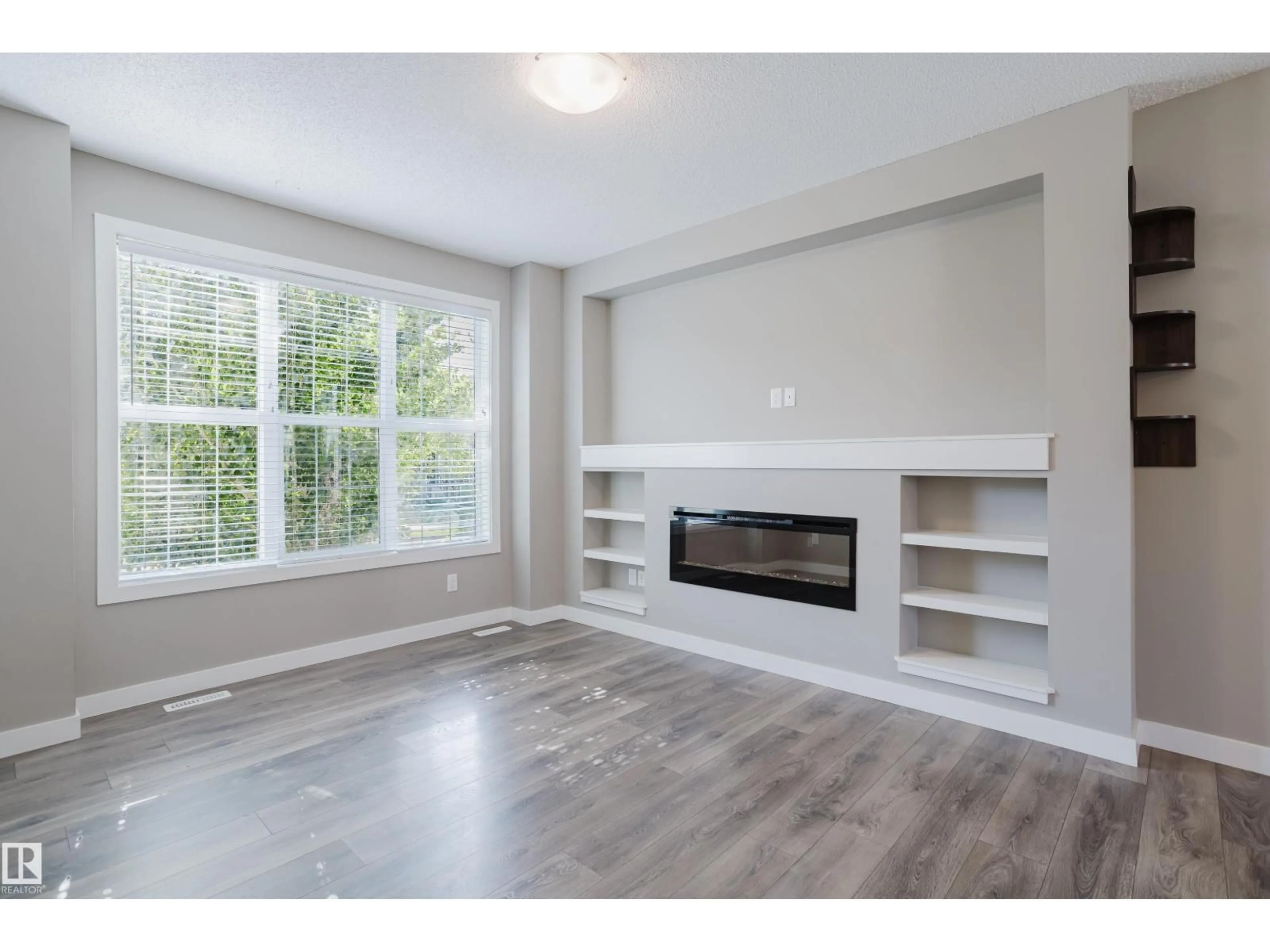 Living room with furniture, wood/laminate floor for 8142 CHAPPELLE WY, Edmonton Alberta T6W3R2