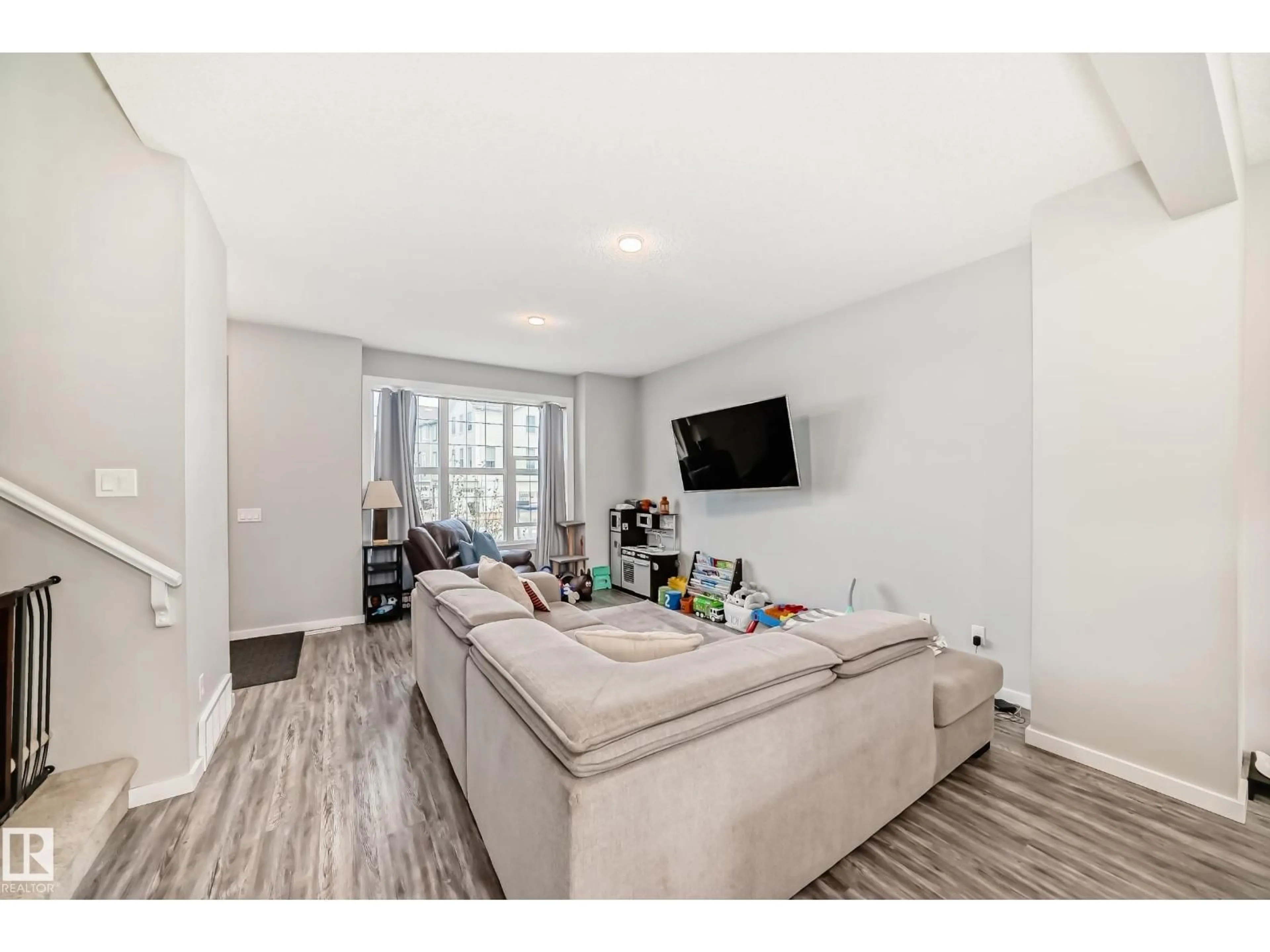 Living room with furniture, wood/laminate floor for 2609 MAPLE WY, Edmonton Alberta T6T2K1