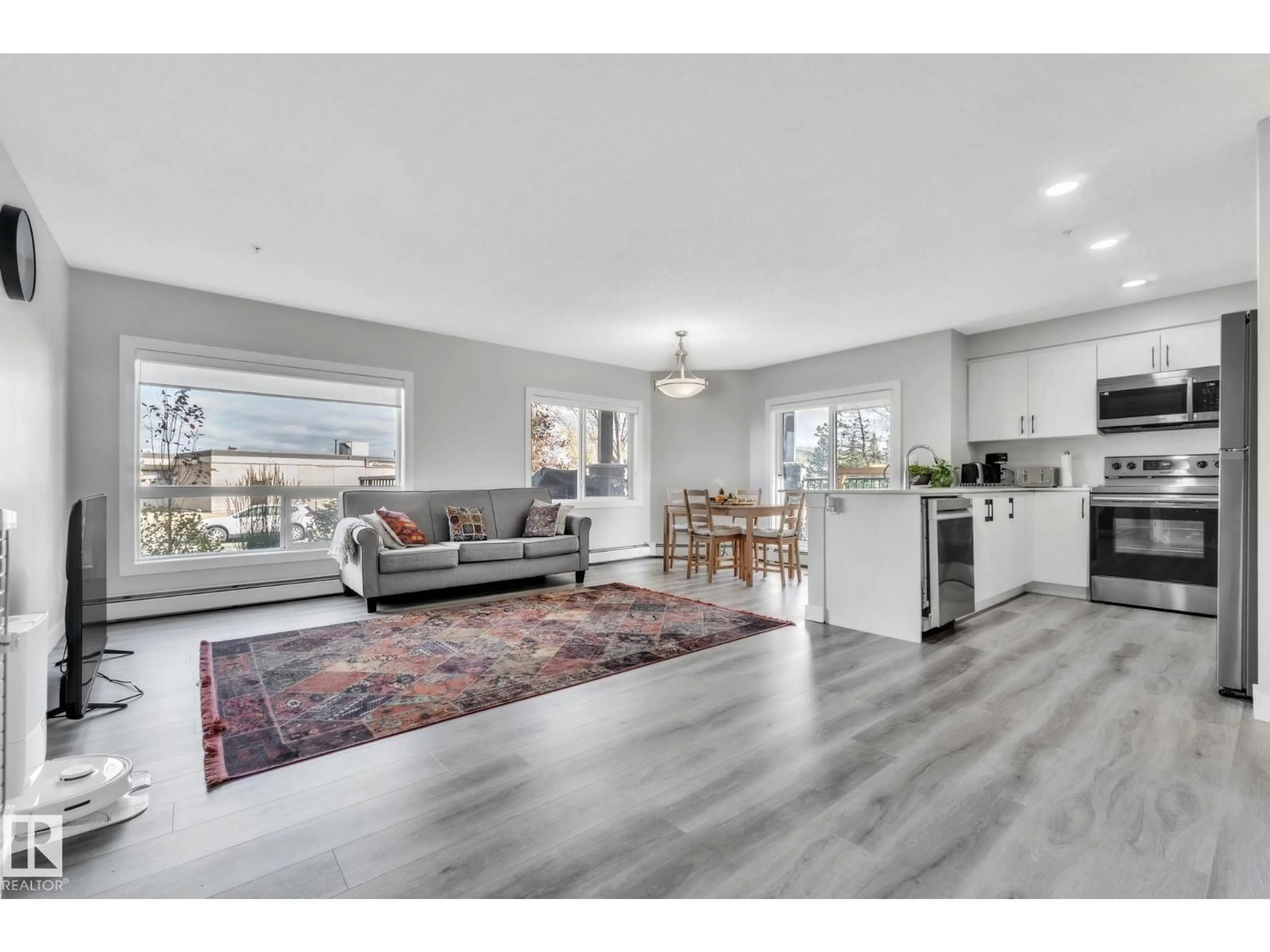 Open concept kitchen, wood/laminate floor for #105 - 11511 27 AV, Edmonton Alberta T6J7J8