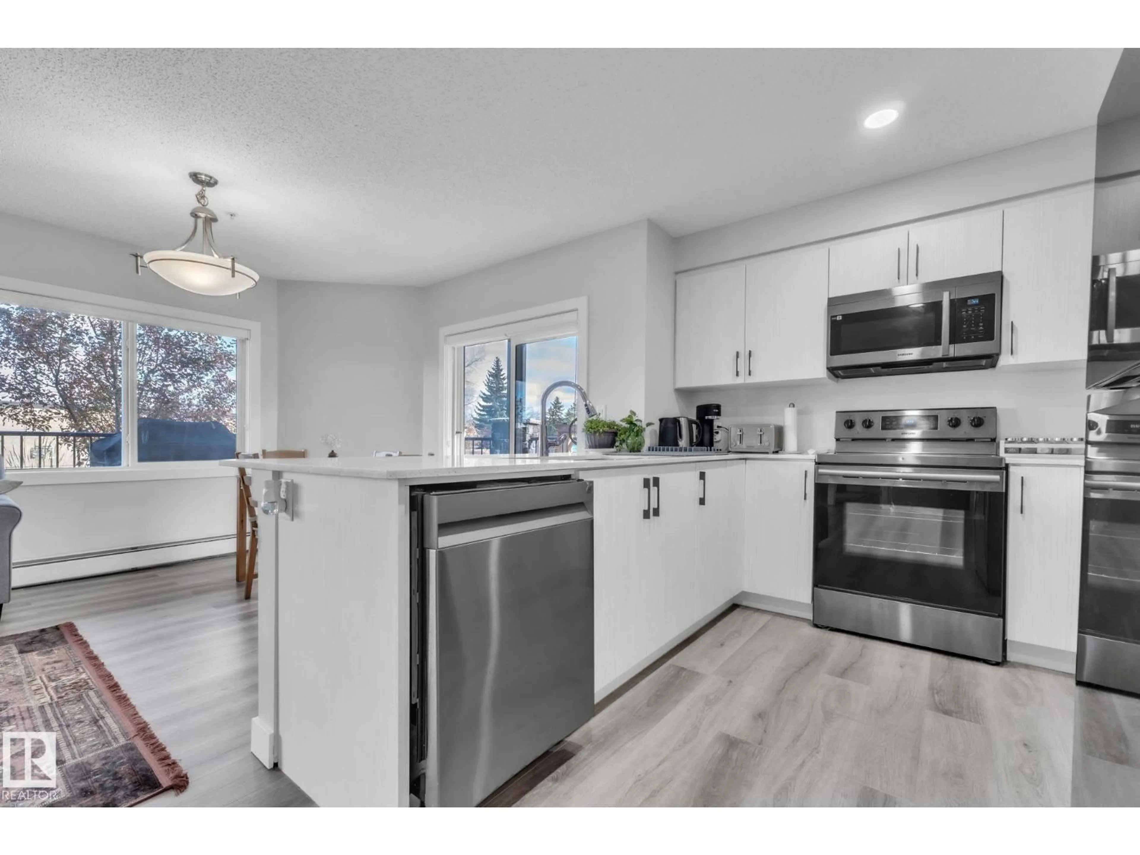 Open concept kitchen, wood/laminate floor for #105 - 11511 27 AV, Edmonton Alberta T6J7J8