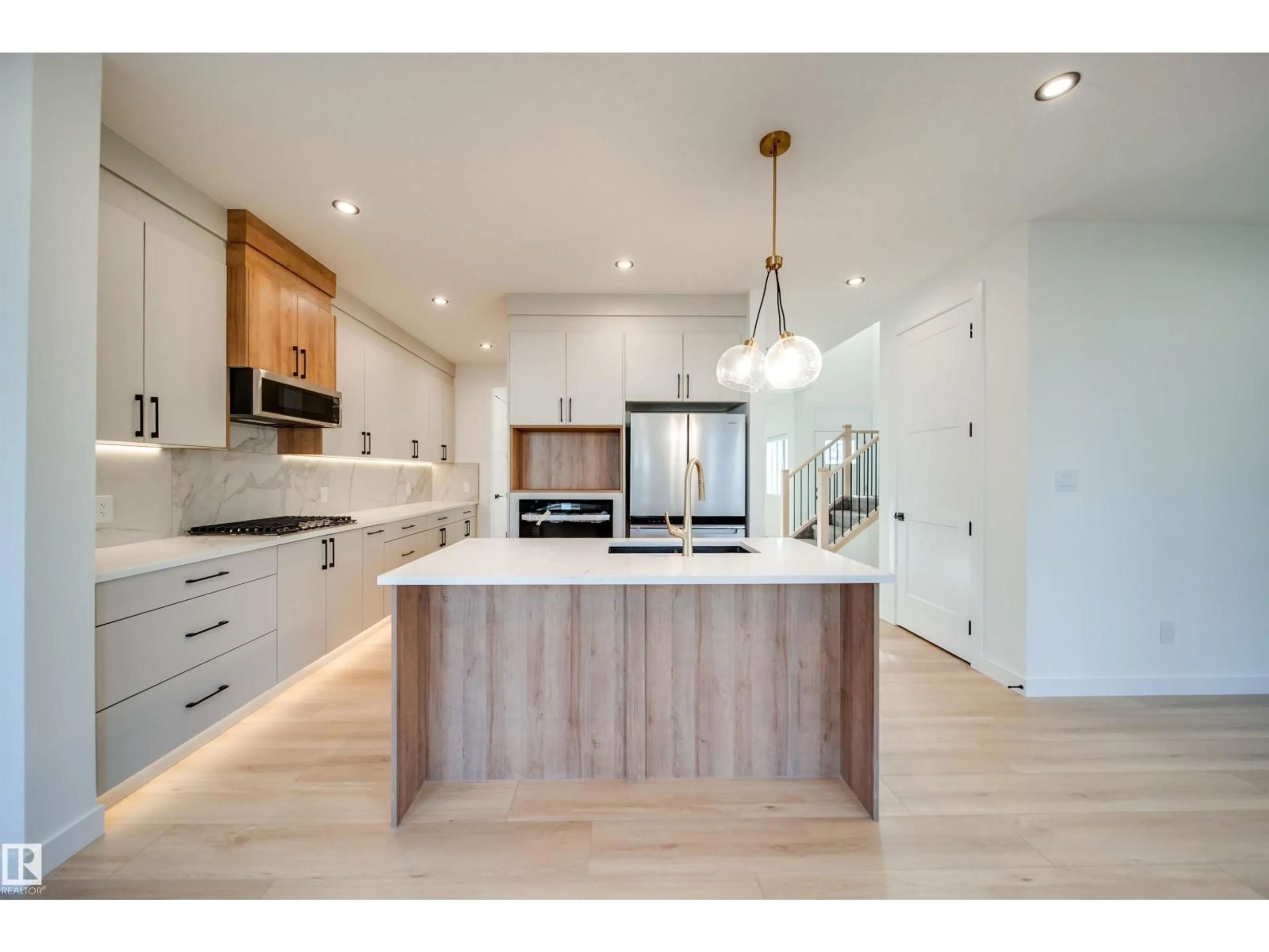 Open concept kitchen, wood/laminate floor for 20 BLACKBIRD BN, Fort Saskatchewan Alberta T8L0G6