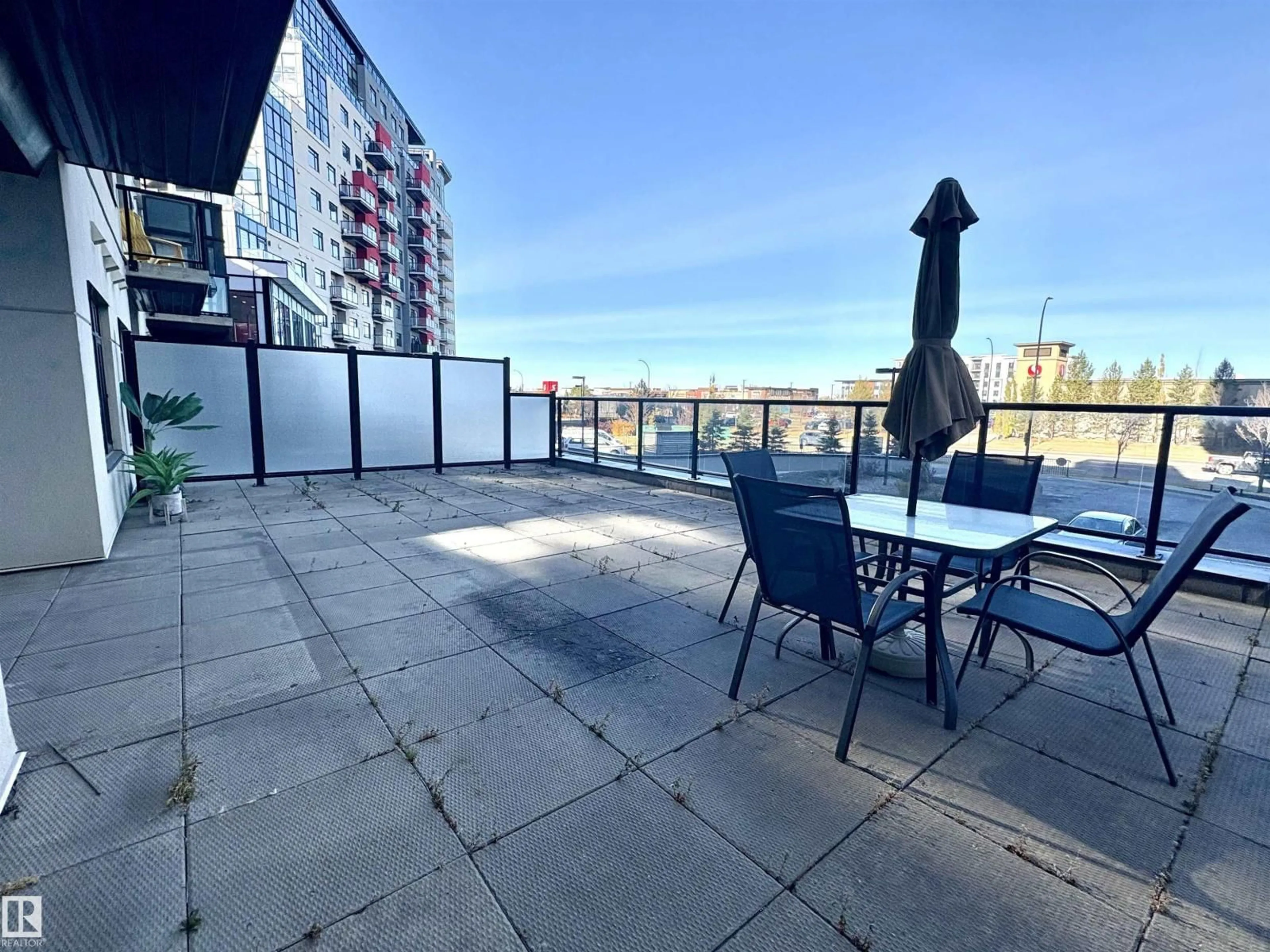 Patio, city buildings view from balcony for #214E - 5151 WINDERMERE BV, Edmonton Alberta T6W2K4