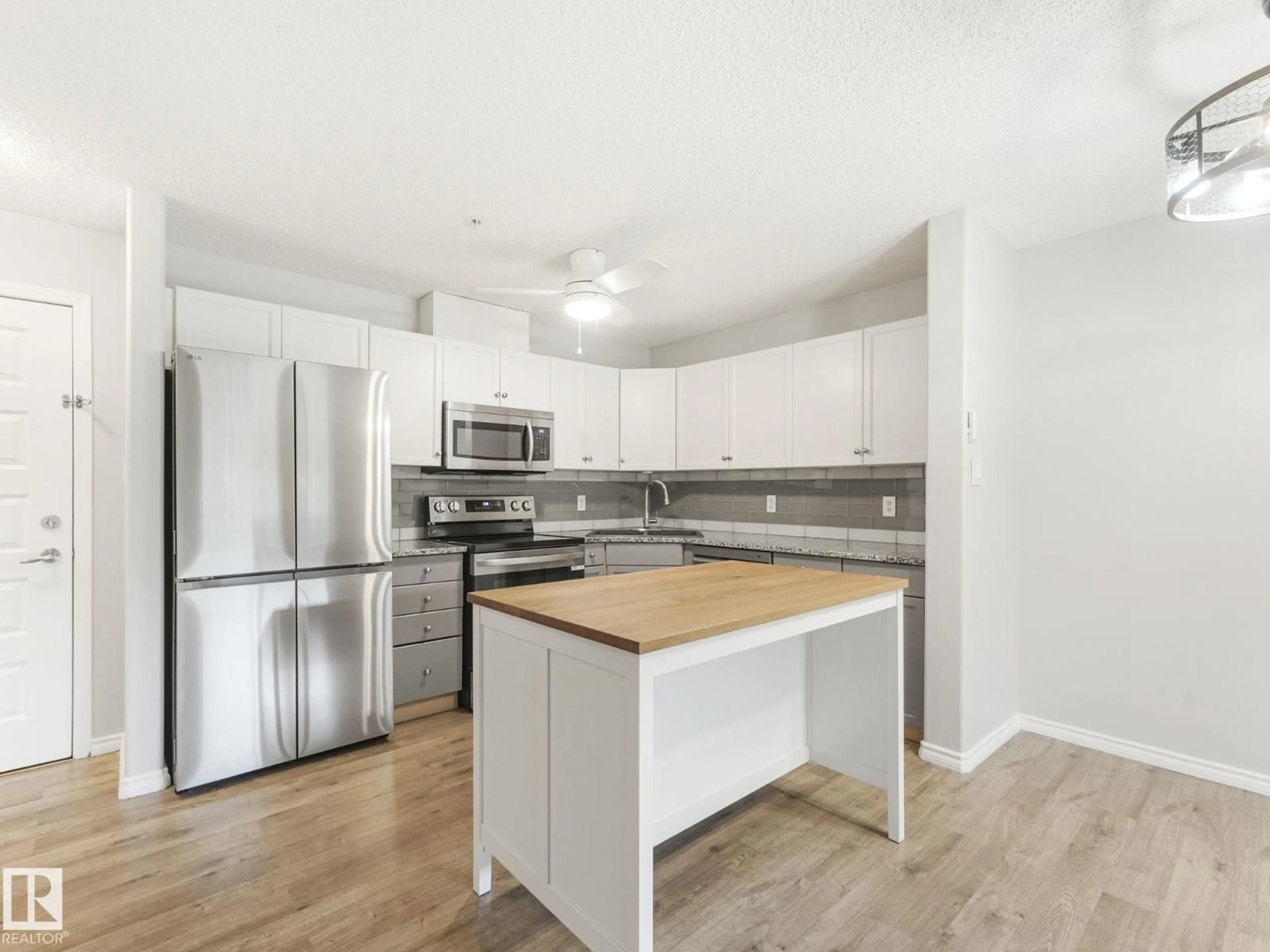 Open concept kitchen, wood/laminate floor for #110 - 646 MCALLISTER LO, Edmonton Alberta T6W0B5