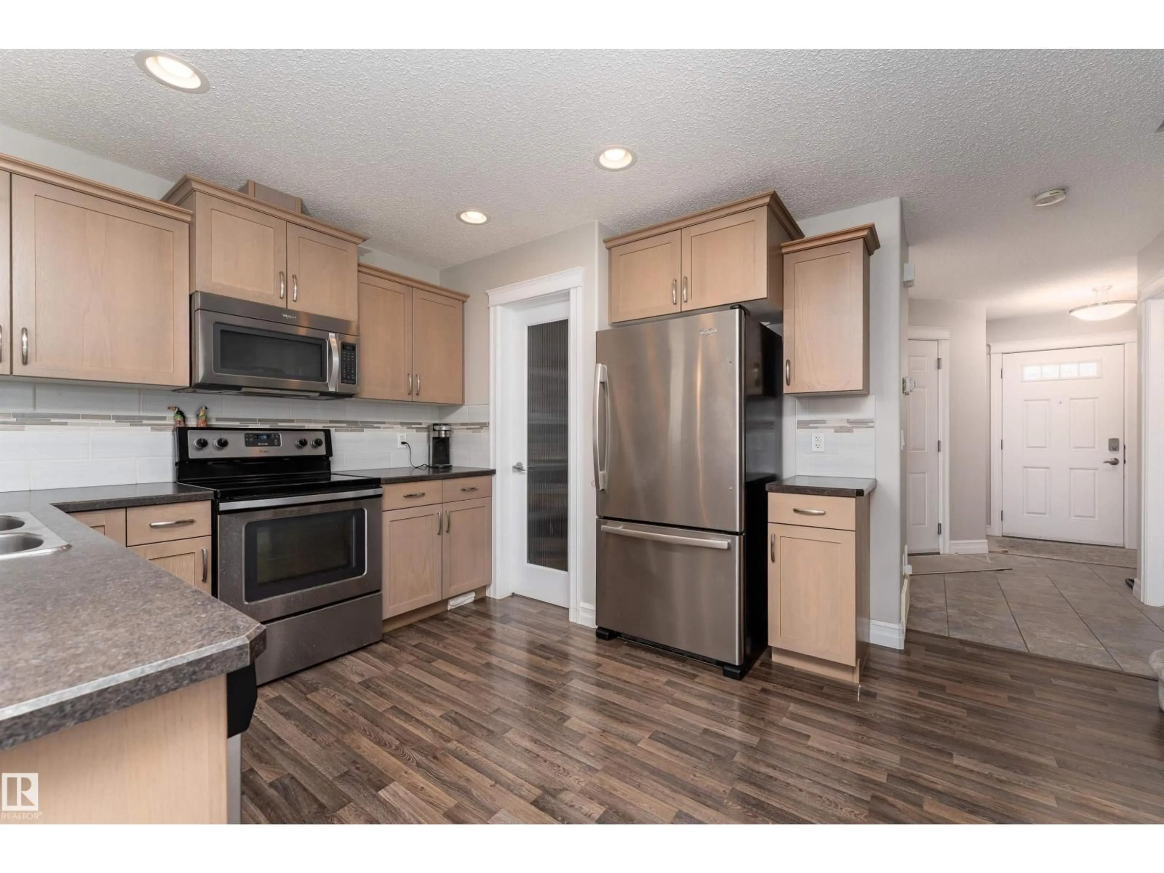 Open concept kitchen, wood/laminate floor for 17111 126 ST, Edmonton Alberta T5X0E5