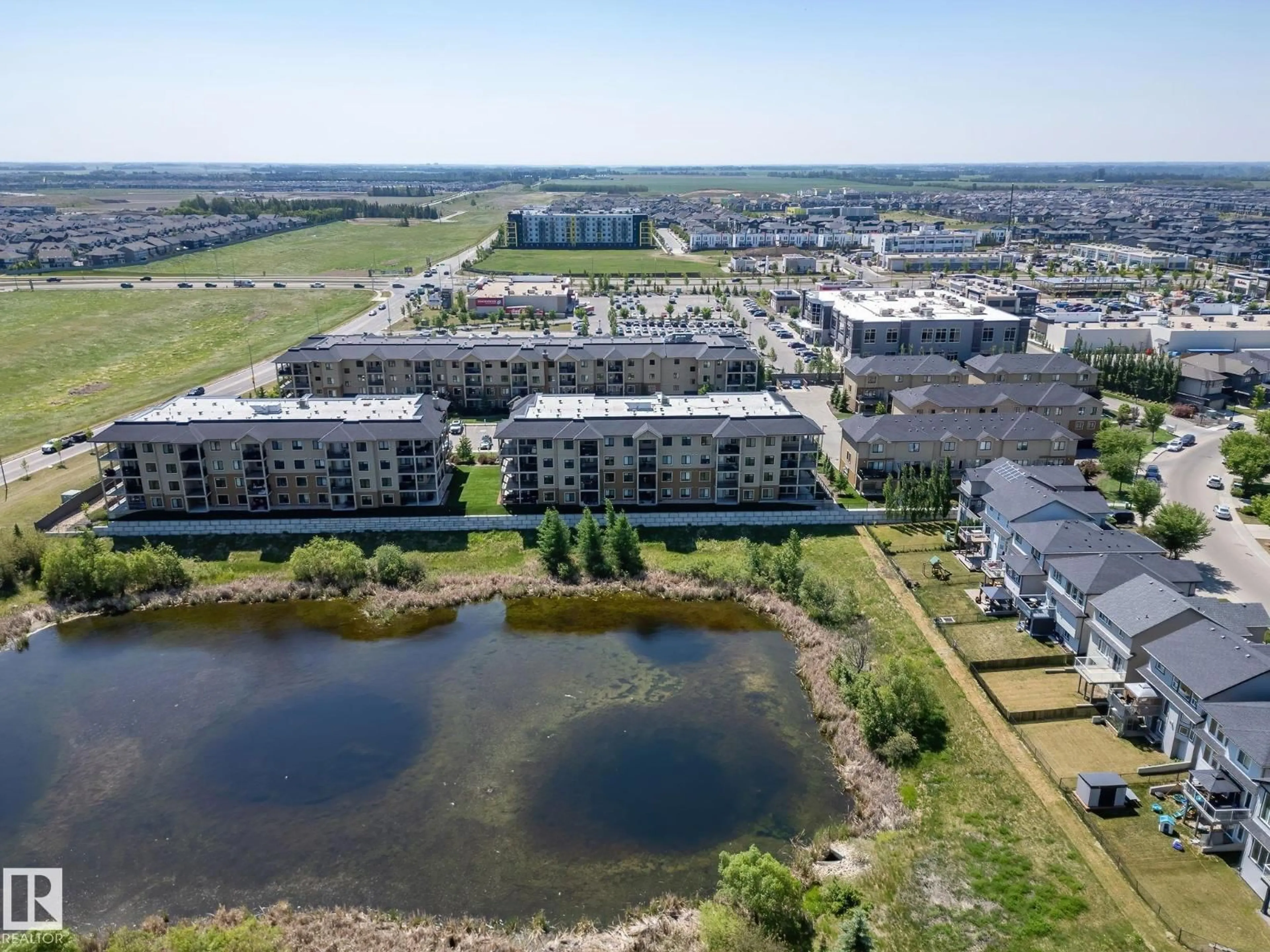 A pic from outside/outdoor area/front of a property/back of a property/a pic from drone, water/lake/river/ocean view for #102 - 1029 173 ST, Edmonton Alberta T6W3E4