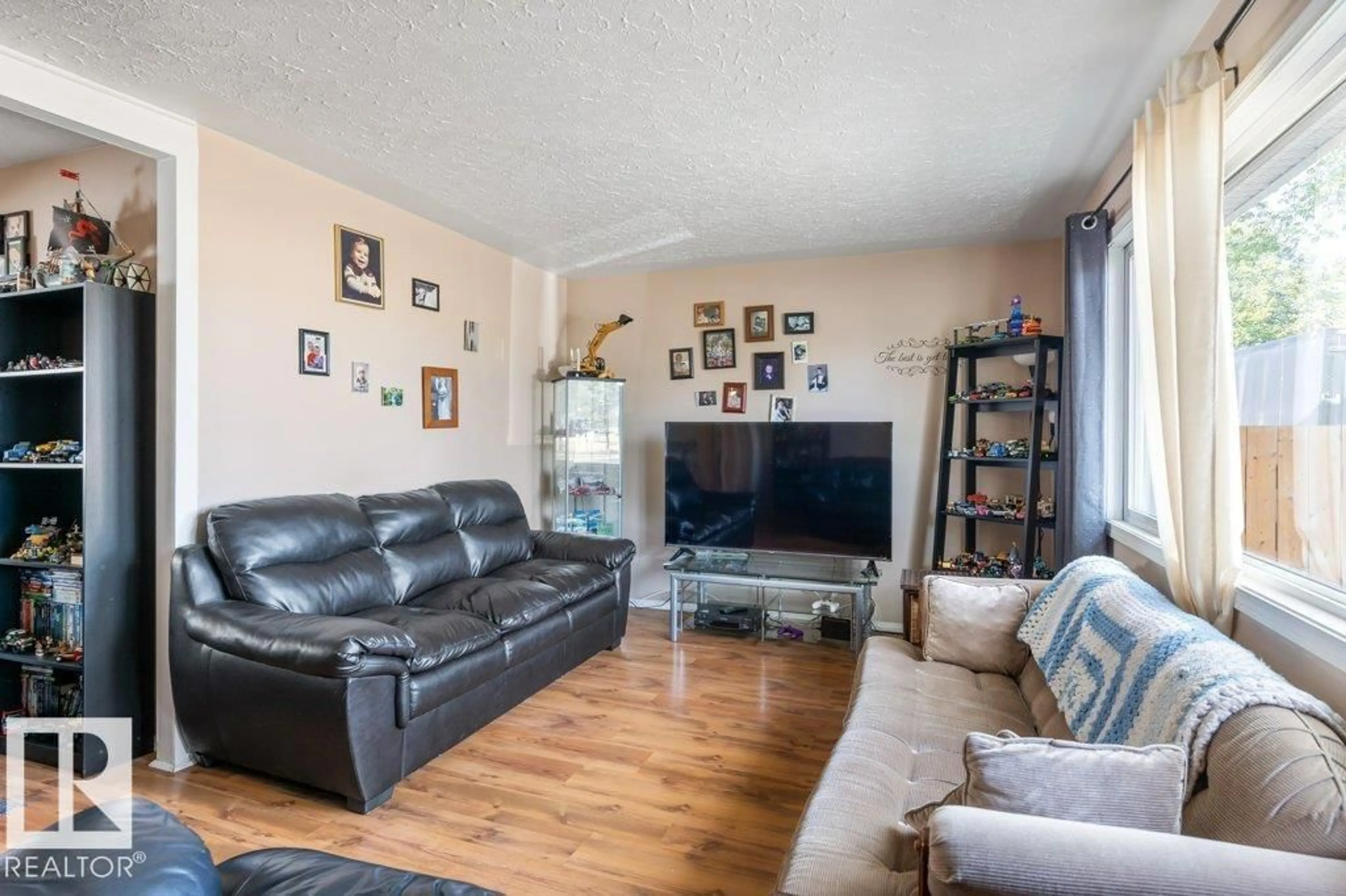 Living room with furniture, wood/laminate floor for 13003 129 AV, Edmonton Alberta T5L3K1