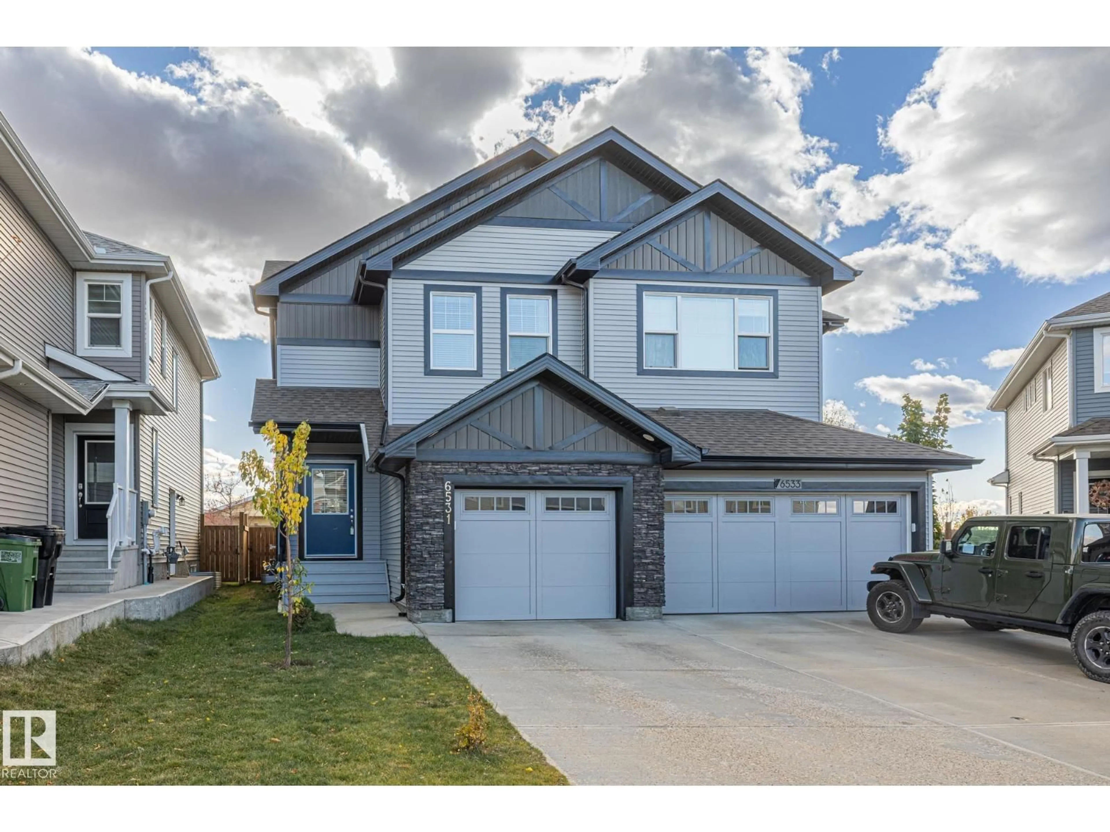 Home with vinyl exterior material, street for 6531 168 AV, Edmonton Alberta T5Y3X9