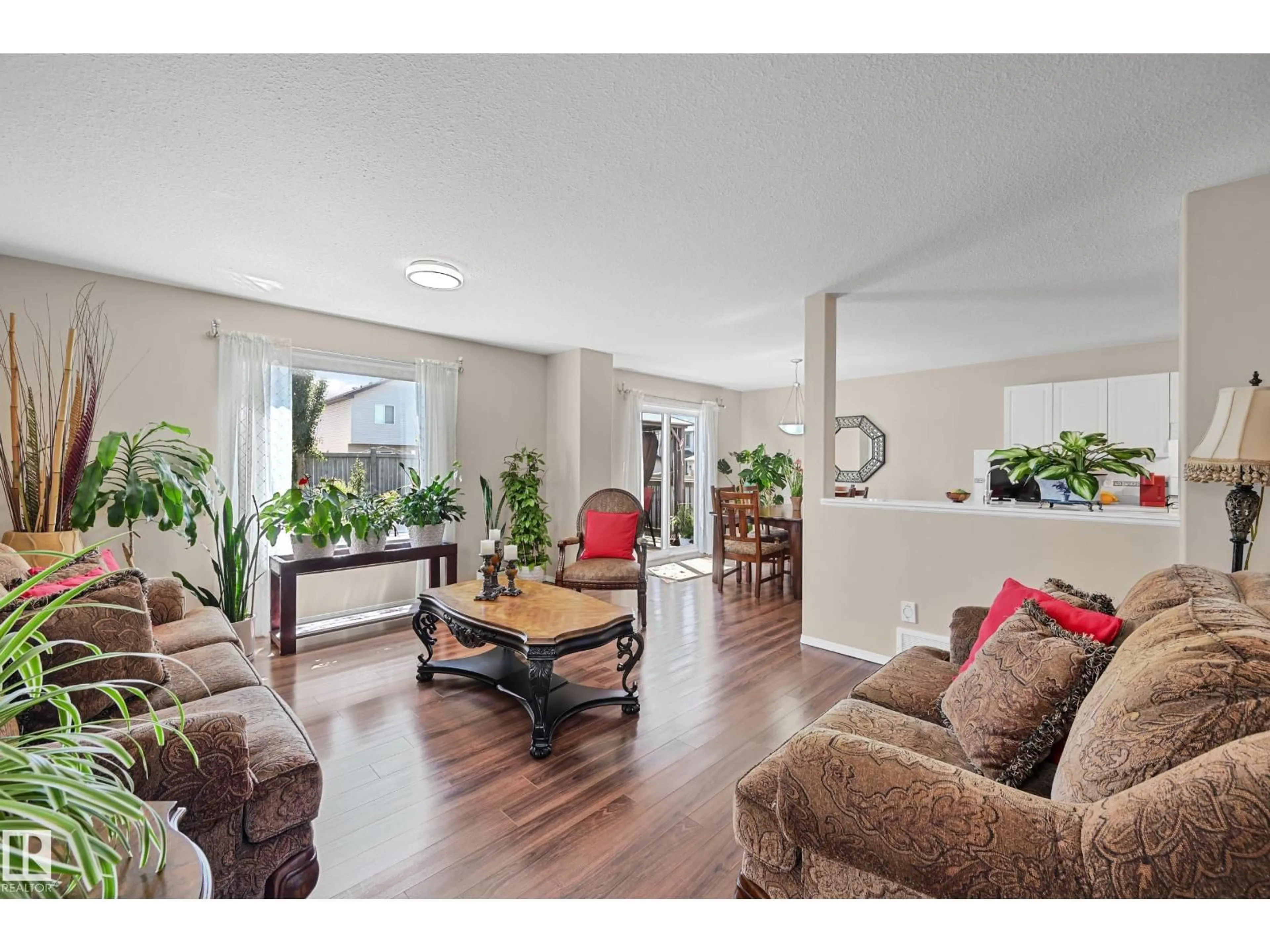Living room with furniture, wood/laminate floor for NW - 3371 25 AV, Edmonton Alberta T6T1Y4