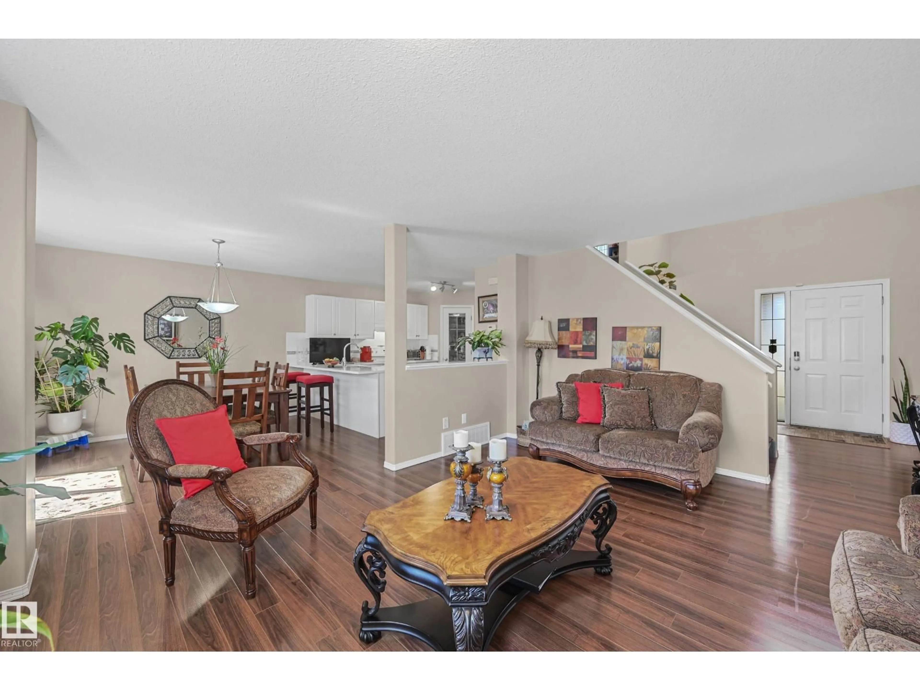 Living room with furniture, wood/laminate floor for NW - 3371 25 AV, Edmonton Alberta T6T1Y4