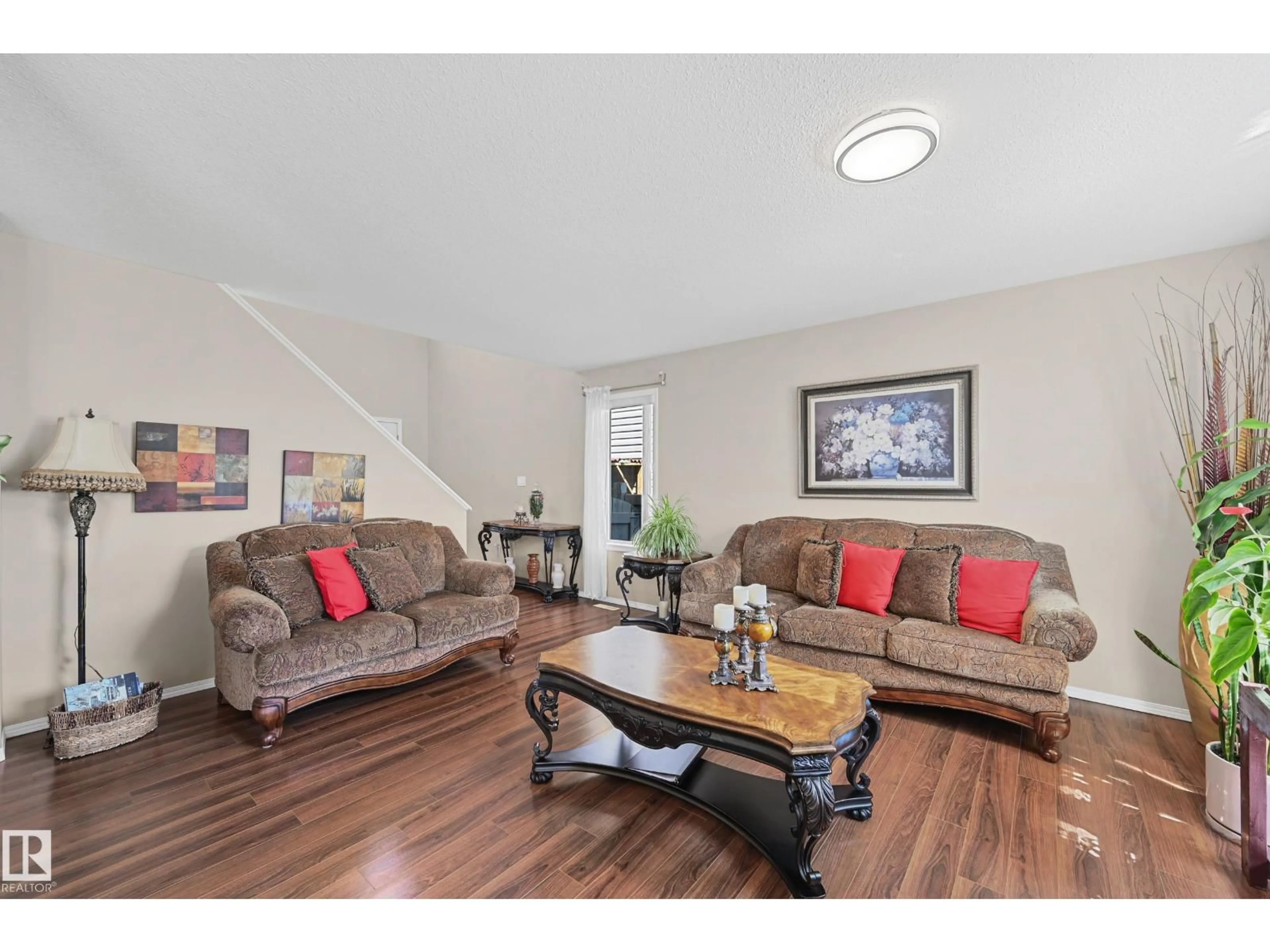 Living room with furniture, wood/laminate floor for NW - 3371 25 AV, Edmonton Alberta T6T1Y4