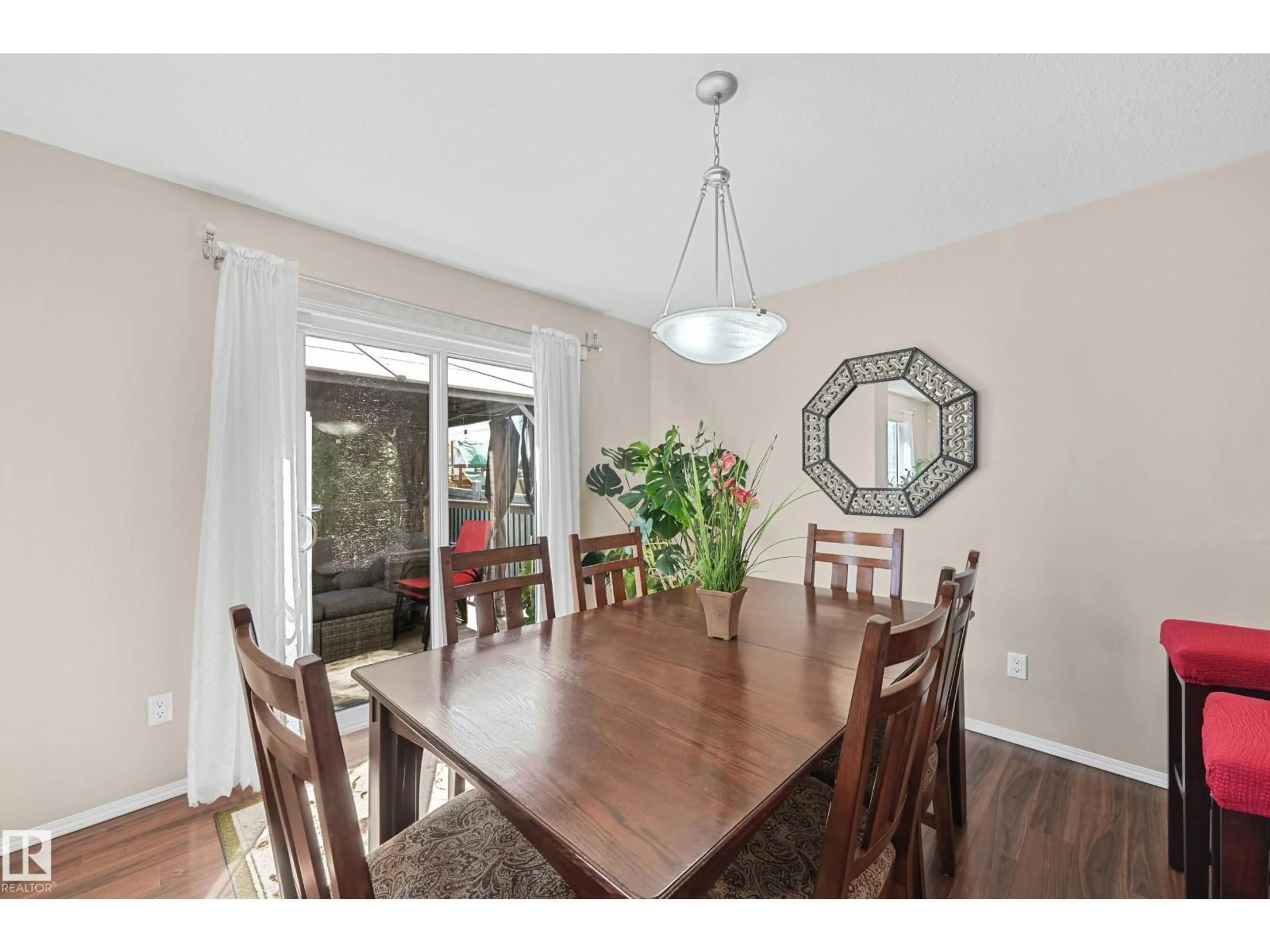 Dining room, wood/laminate floor for NW - 3371 25 AV, Edmonton Alberta T6T1Y4