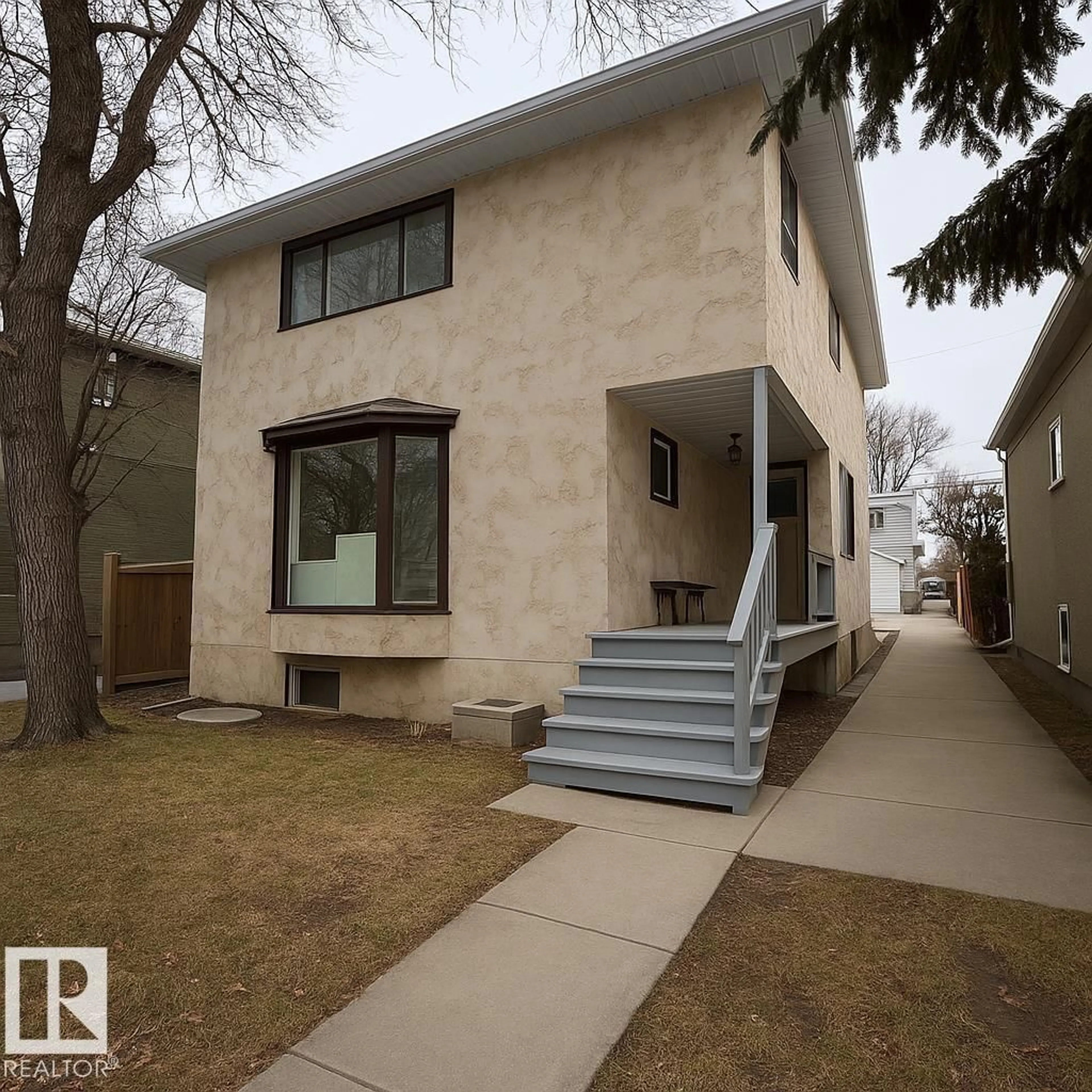 Home with vinyl exterior material, street for 10934 76 AV, Edmonton Alberta T6G0J7