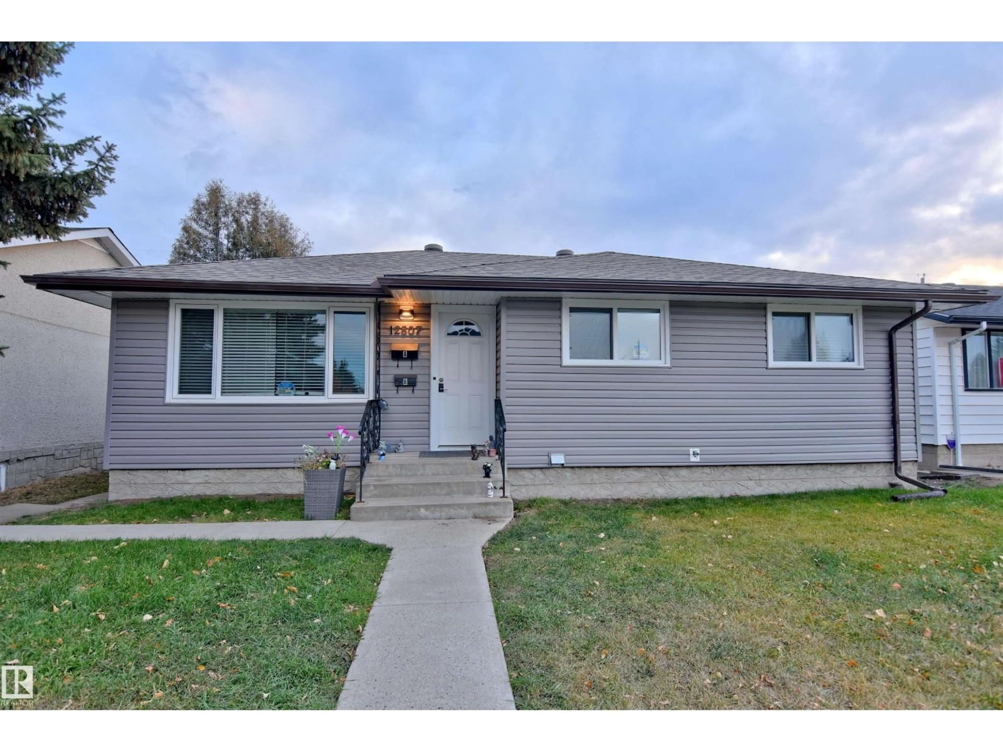 Home with vinyl exterior material, street for NW - 12807 135 AV, Edmonton Alberta T5L3X4