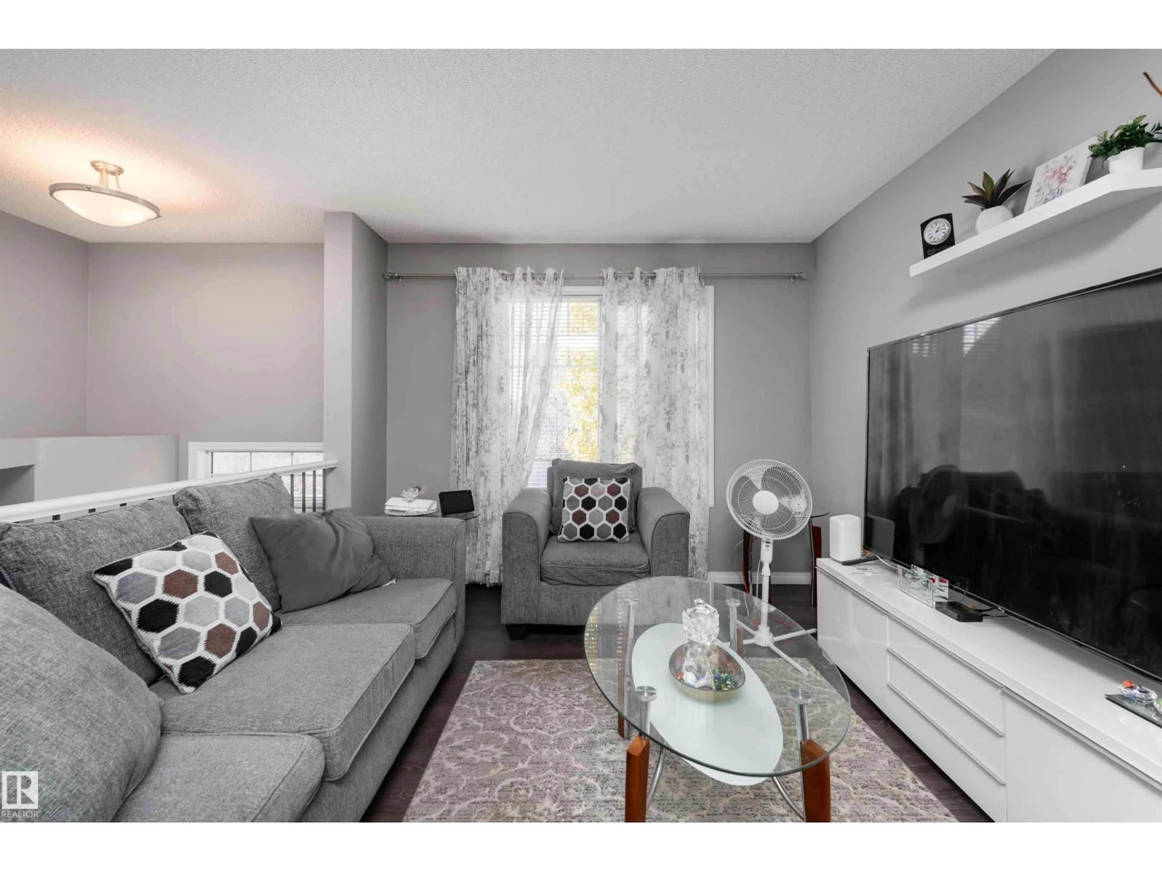 Living room with furniture, wood/laminate floor for #6 - 4050 SAVARYN DR, Edmonton Alberta T6X1R8