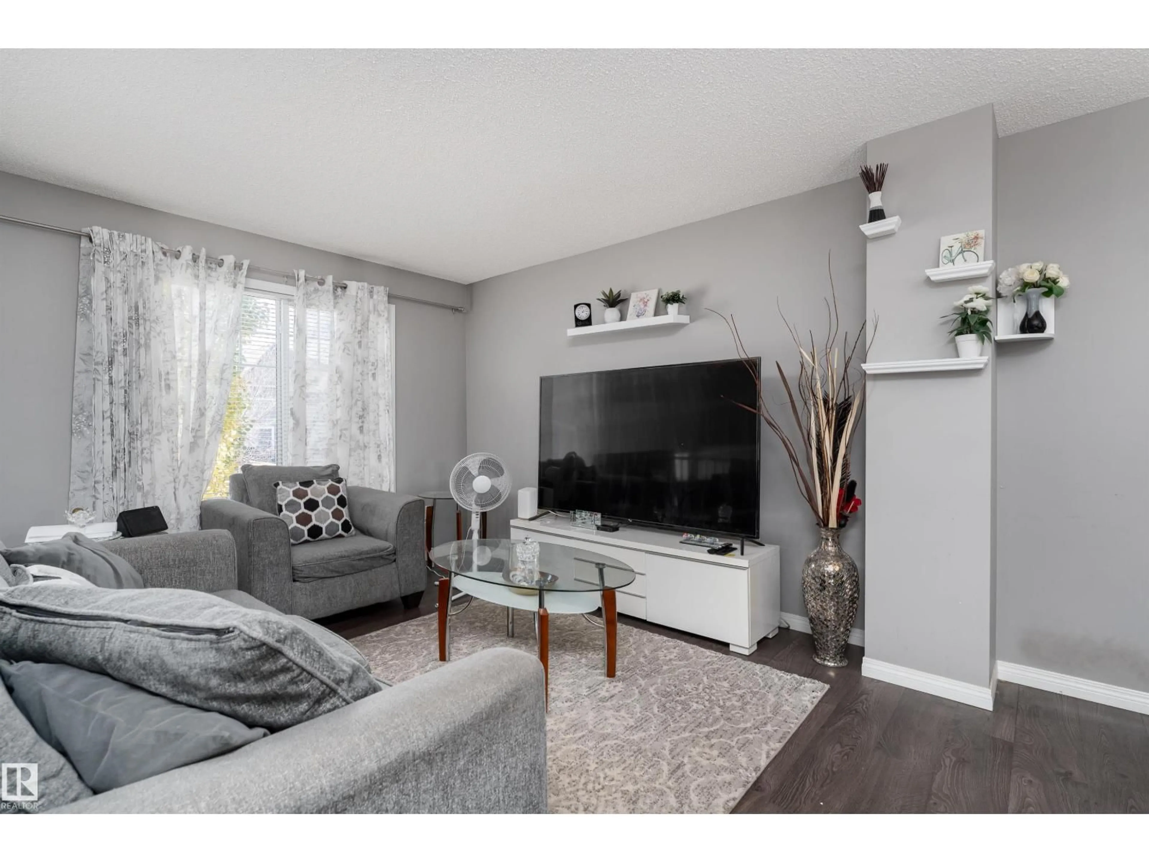 Living room with furniture, wood/laminate floor for #6 - 4050 SAVARYN DR, Edmonton Alberta T6X1R8