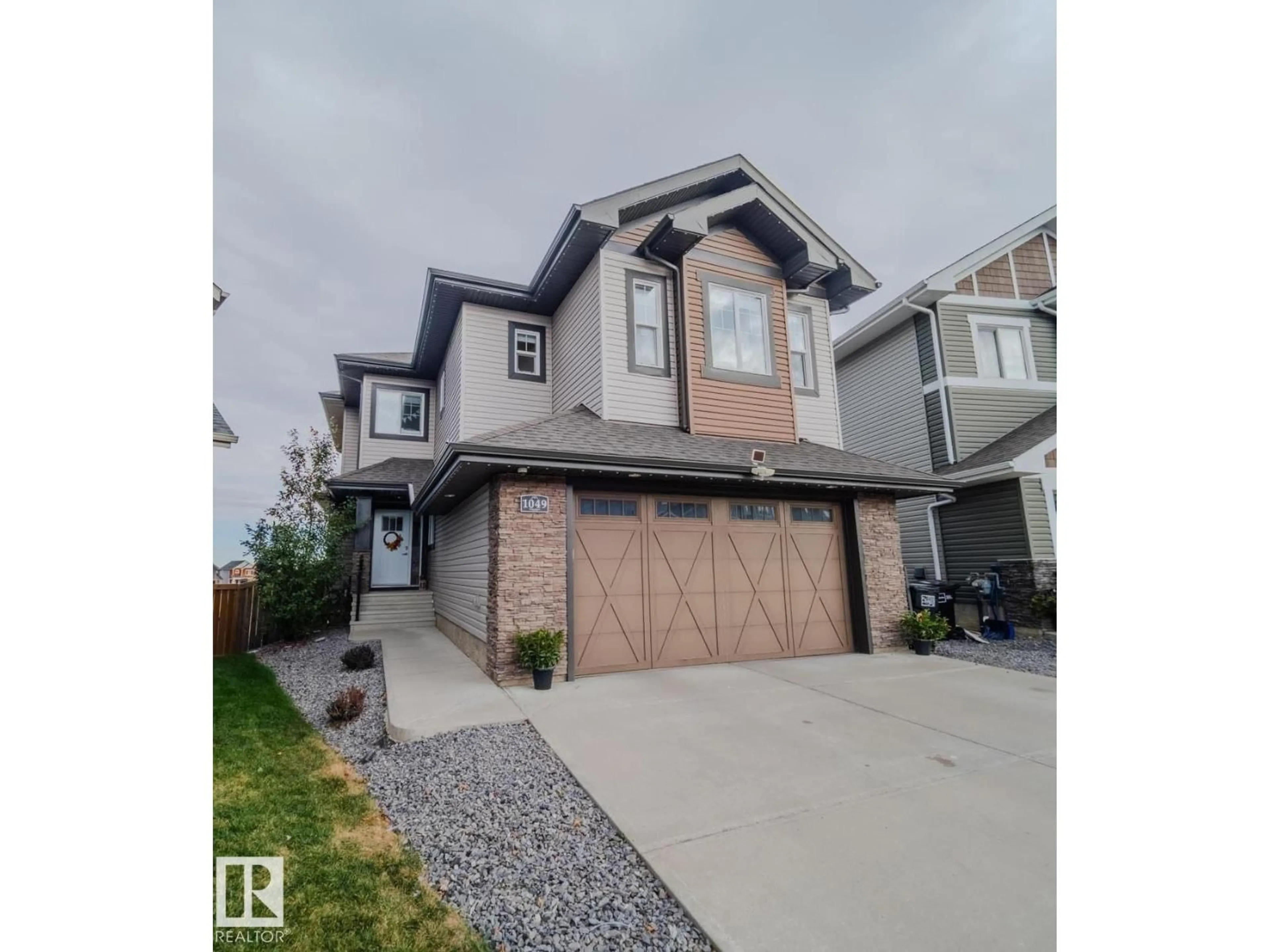 Home with vinyl exterior material, street for LI NW - 1049 COOPERS HAWK LINK, Edmonton Alberta T5S0M2
