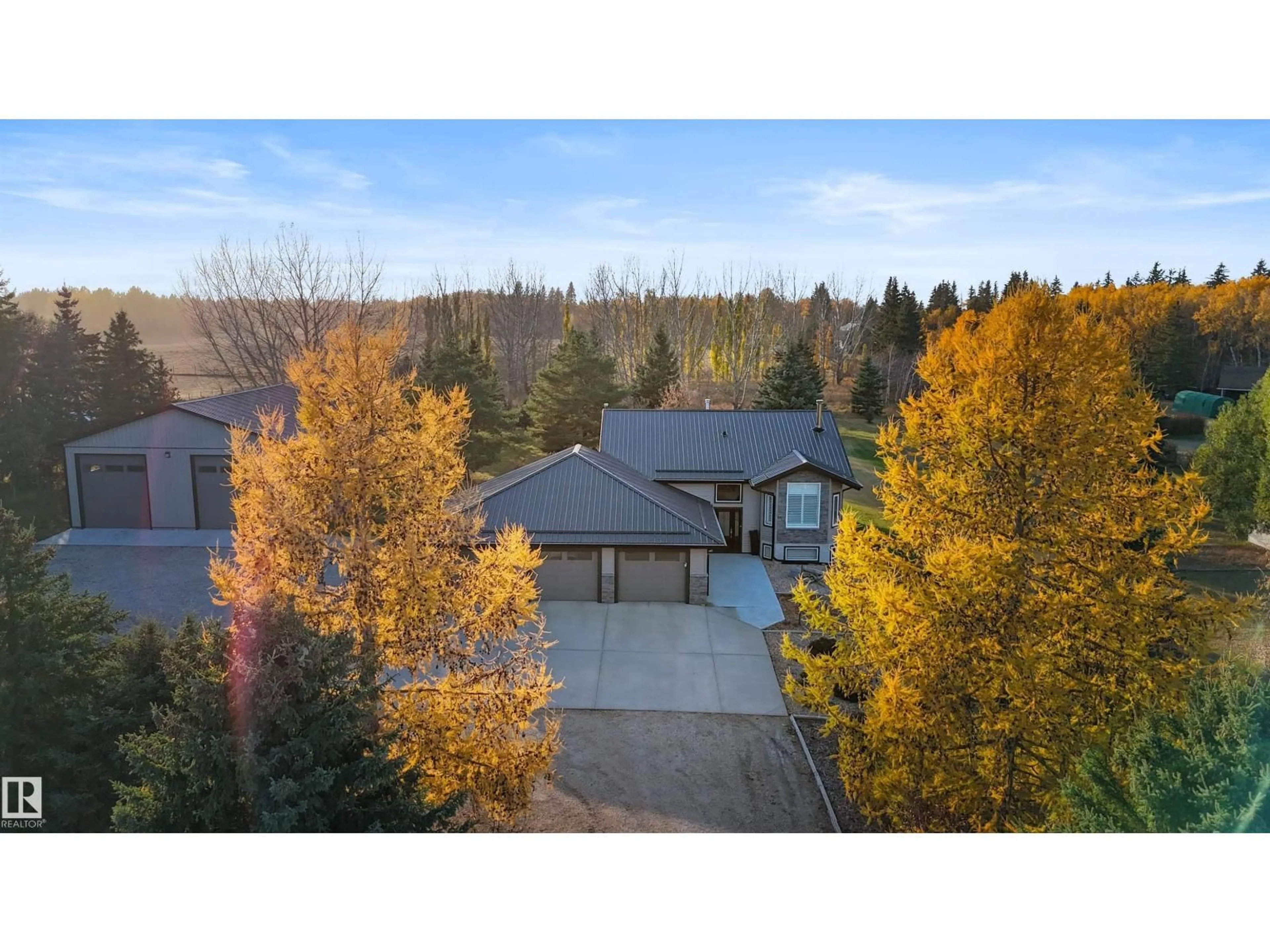 A pic from outside/outdoor area/front of a property/back of a property/a pic from drone, forest/trees view for #4 - 27005 TWP ROAD 511, Rural Parkland County Alberta T7Z1R1