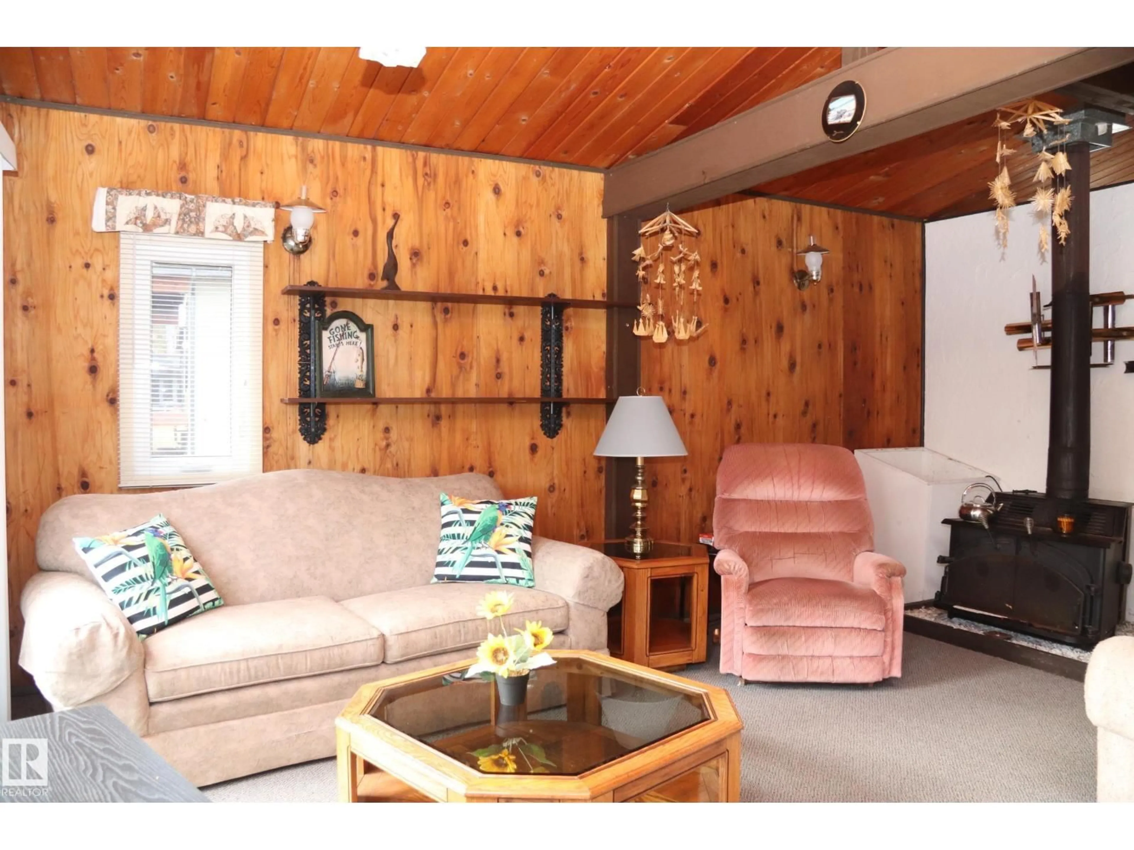 Living room with furniture, wood/laminate floor for 603 LONG LAKE DR, Long Lake Alberta T6A0M0