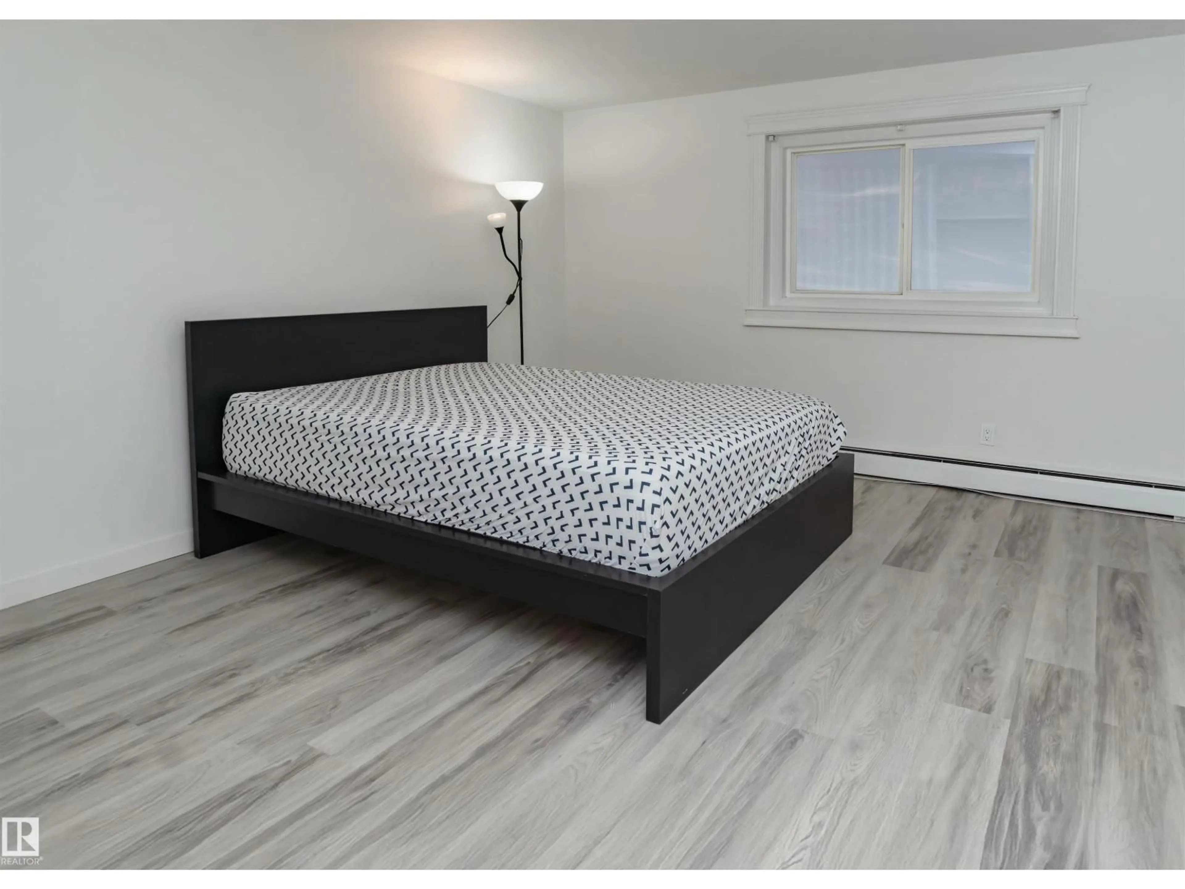Bedroom with bed, wood/laminate floor for #107 - 7204 81 AV, Edmonton Alberta T6B0E2