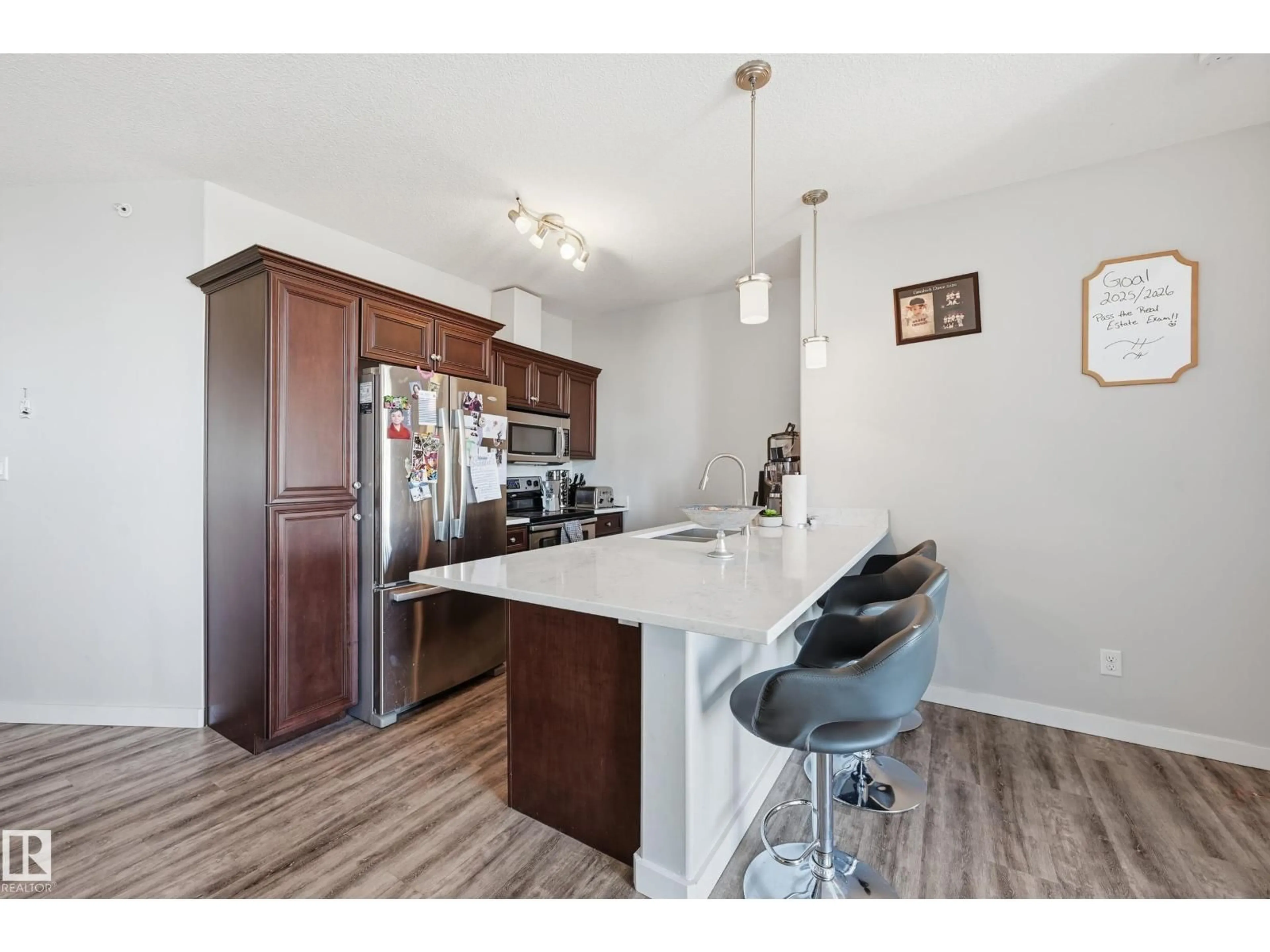 Open concept kitchen, wood/laminate floor for 304 - 411 AMBLESIDE LINK LI, Edmonton Alberta T6W0V2