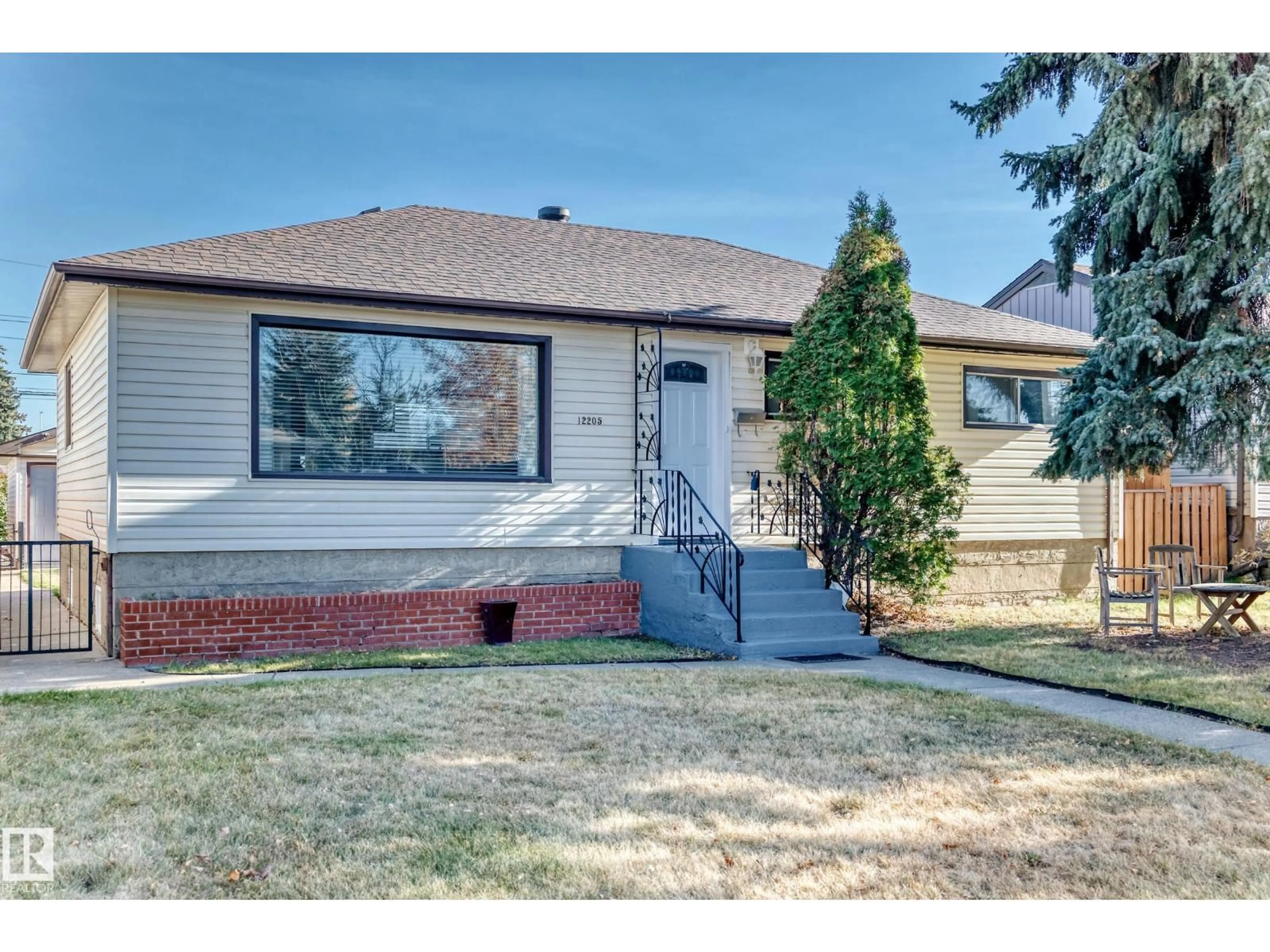 Home with vinyl exterior material, street for 12205 37 ST, Edmonton Alberta T5W2C6