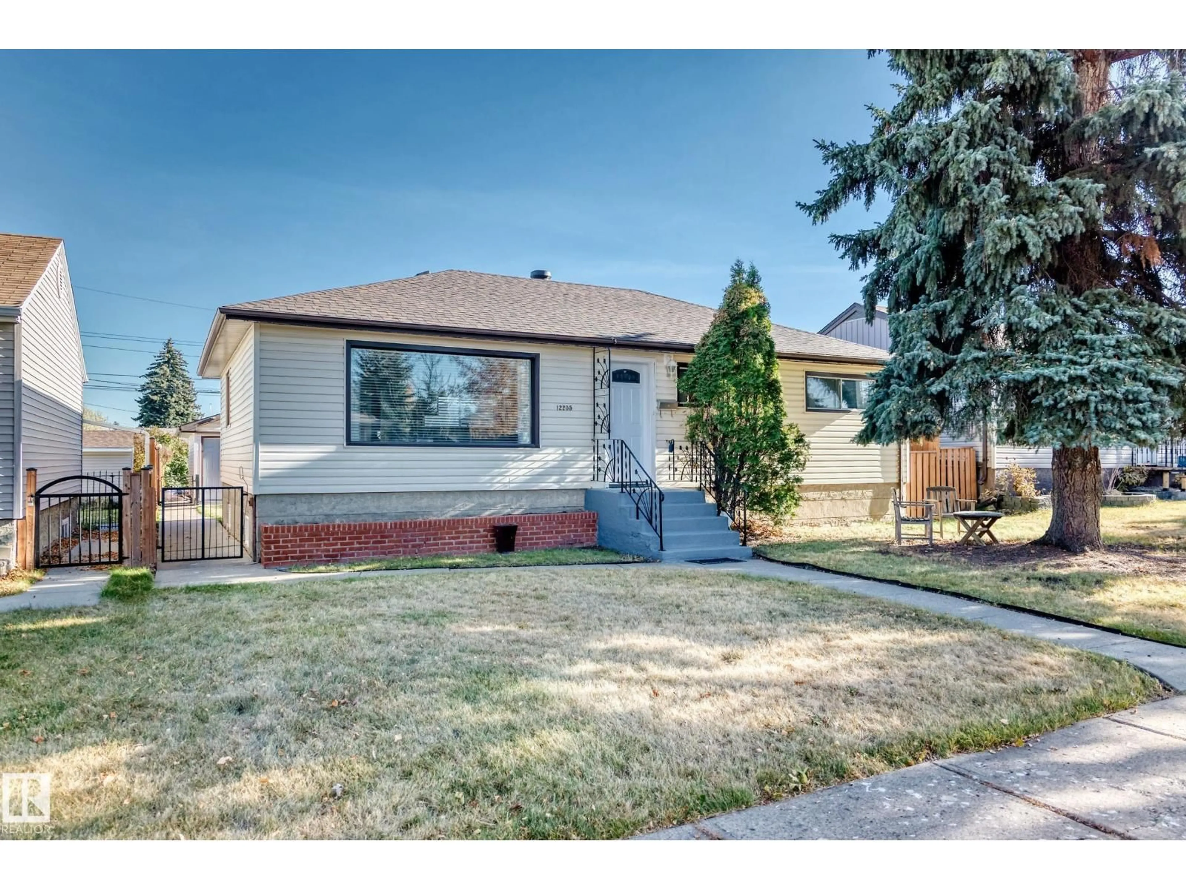 Home with vinyl exterior material, street for 12205 37 ST, Edmonton Alberta T5W2C6