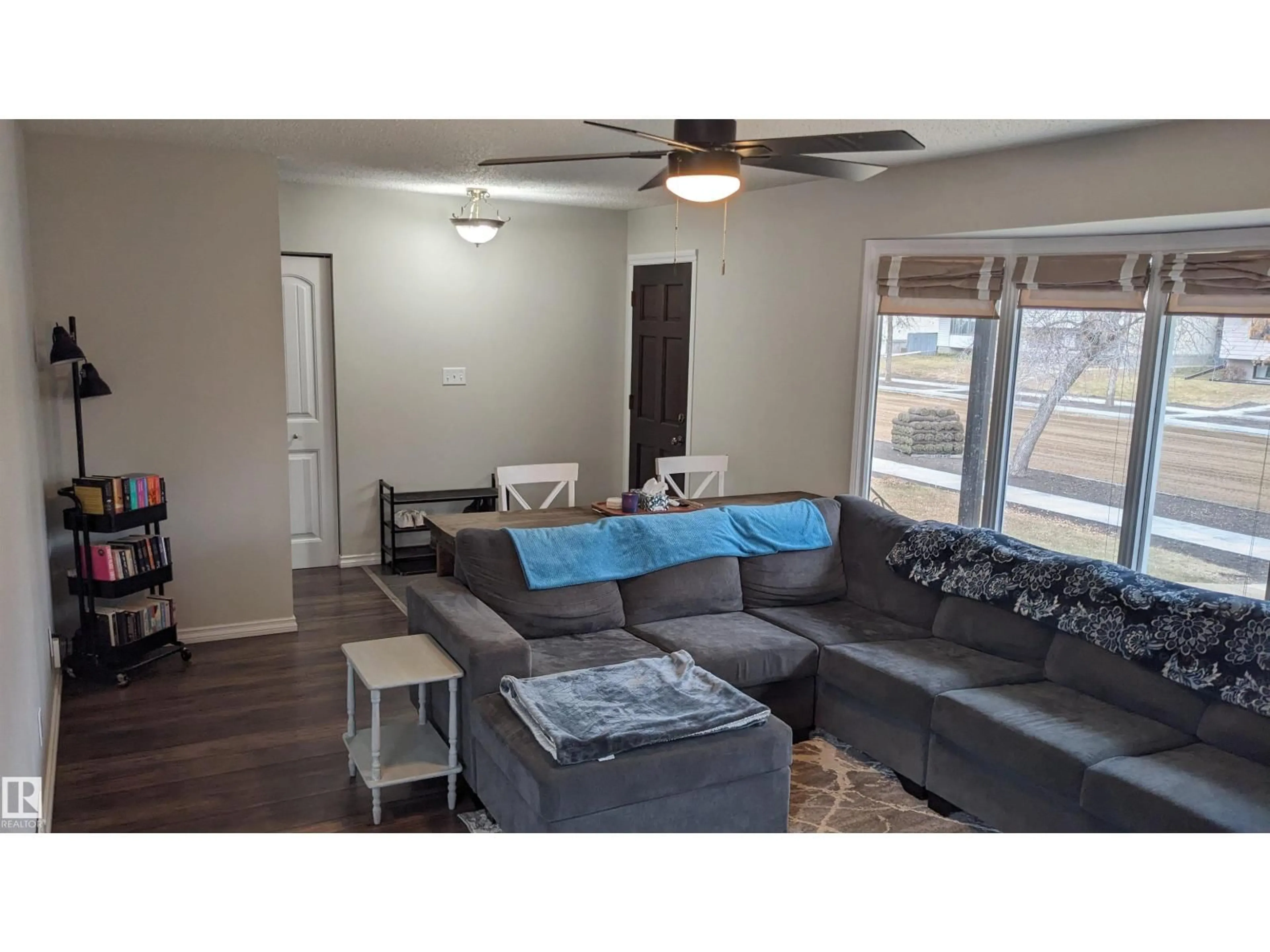 Living room with furniture, wood/laminate floor for 6307 MARLER DR, Camrose Alberta T4V2Y6