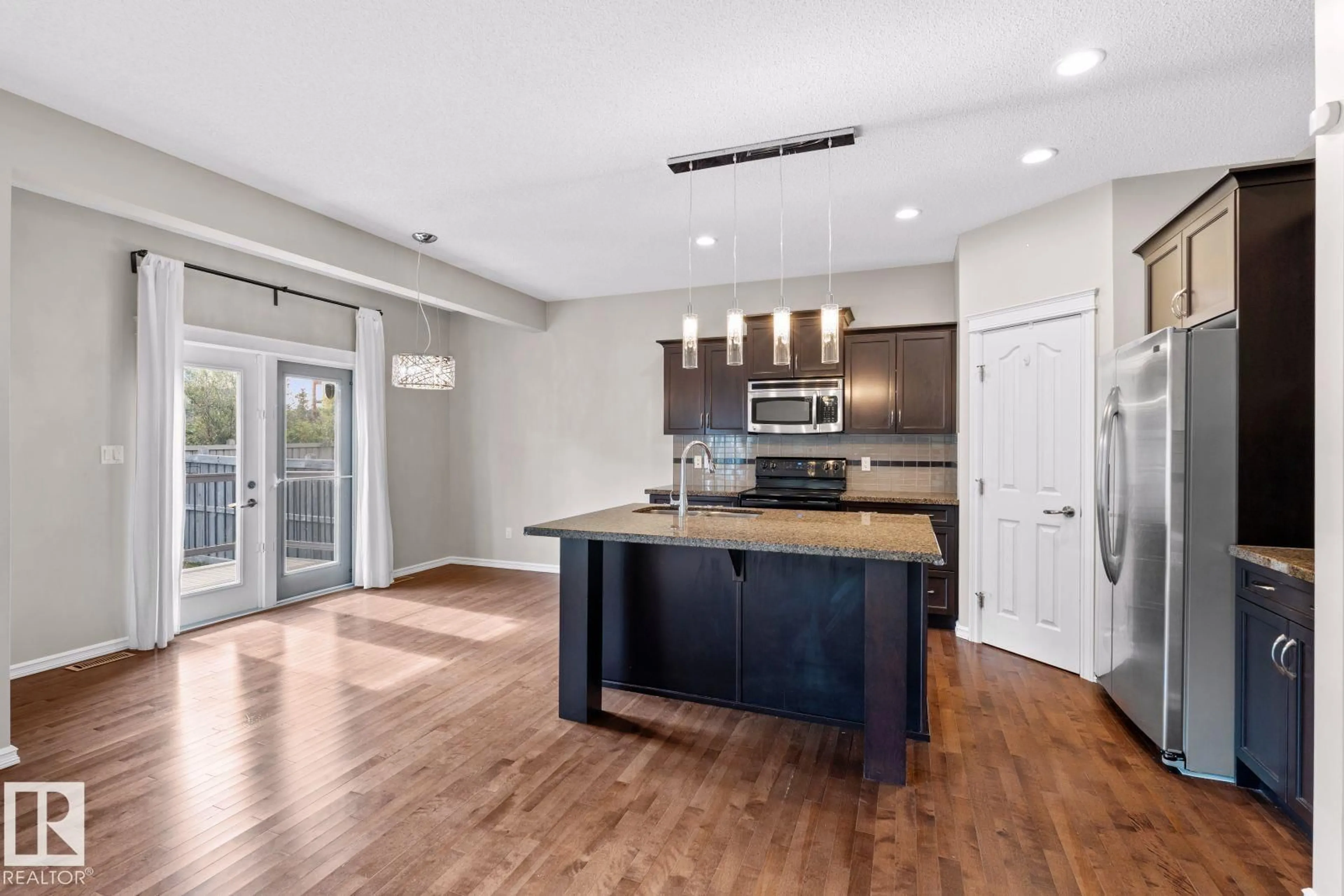 Open concept kitchen, wood/laminate floor for 716 ADAMS WY, Edmonton Alberta T6W0K2