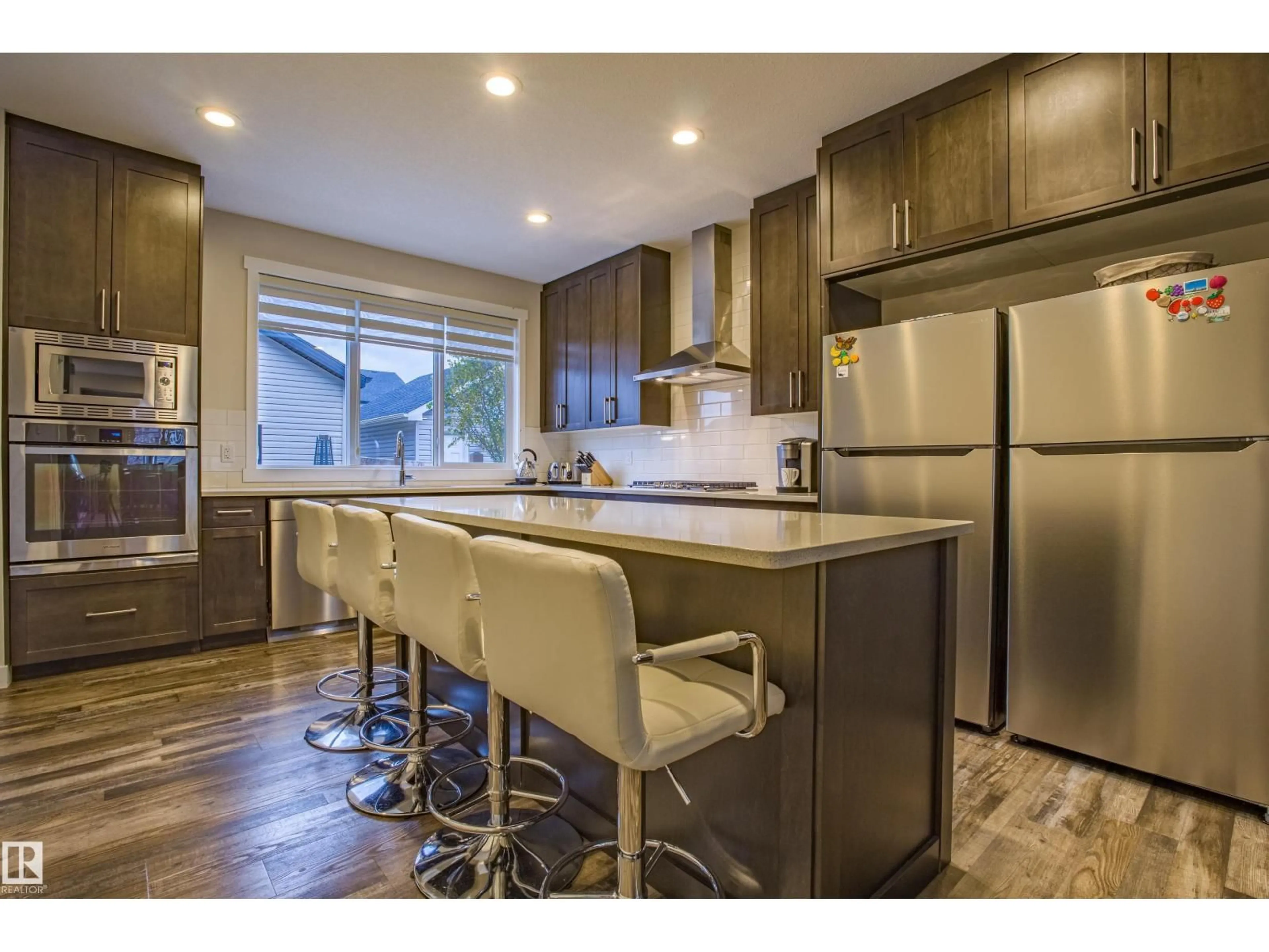 Open concept kitchen, wood/laminate floor for 9868 206 ST NW, Edmonton Alberta T5T7L5