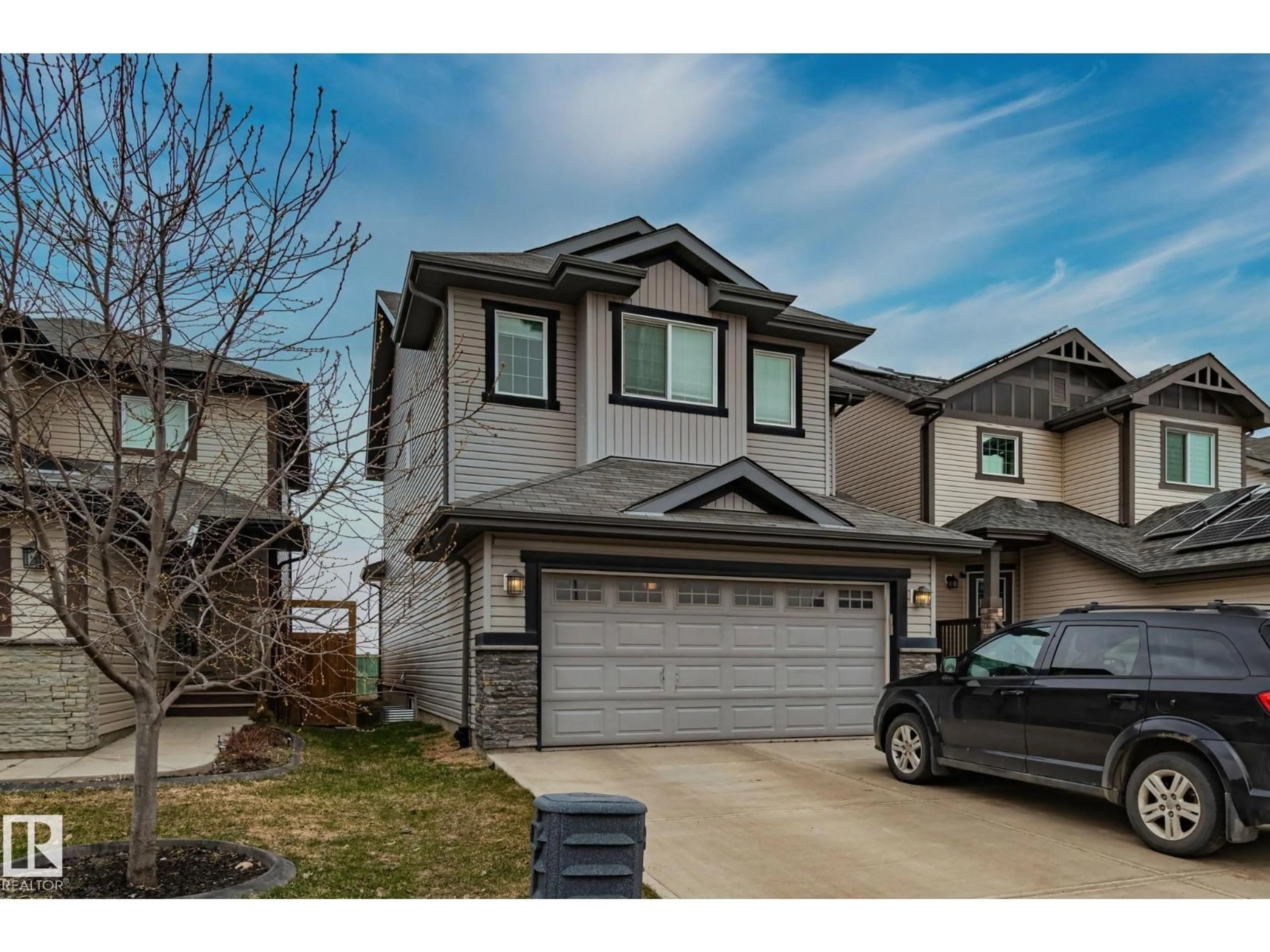 Home with vinyl exterior material, street for 16404 12 AV, Edmonton Alberta T6W3K4