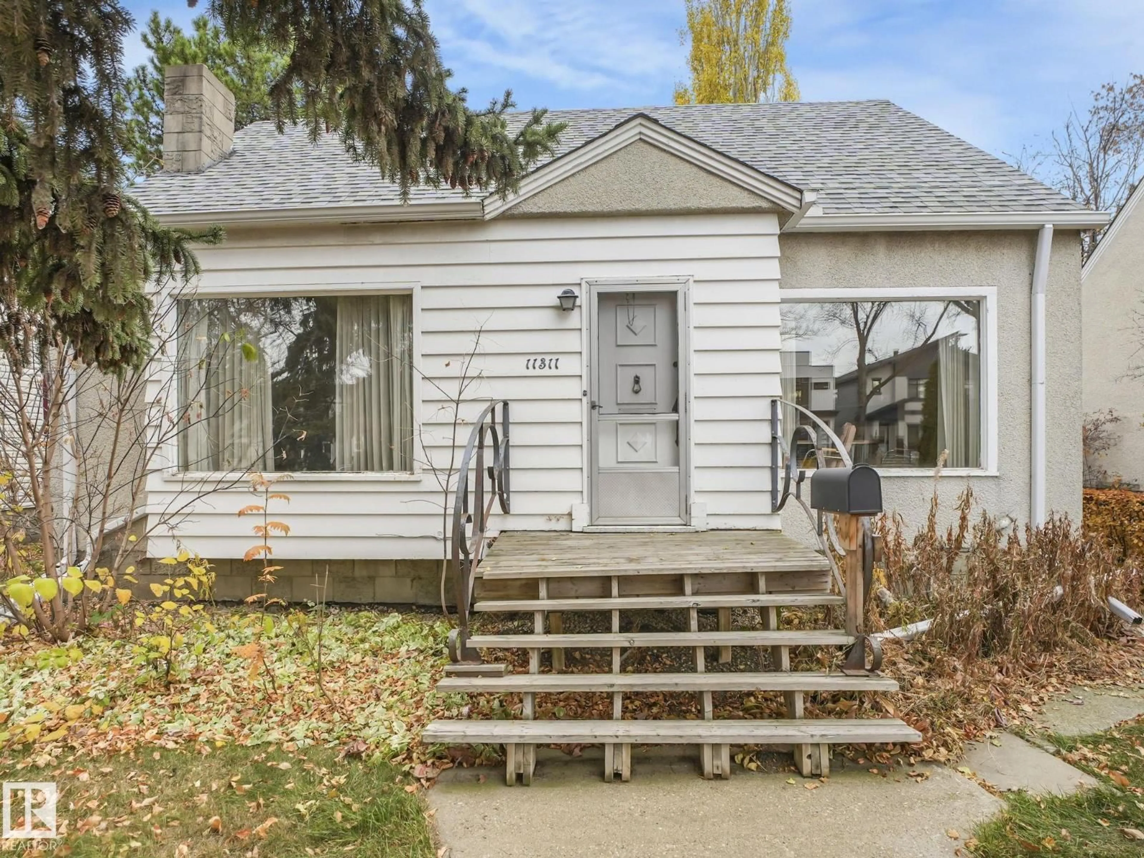 Home with vinyl exterior material, street for 11311 75 AV, Edmonton Alberta T6G0H6