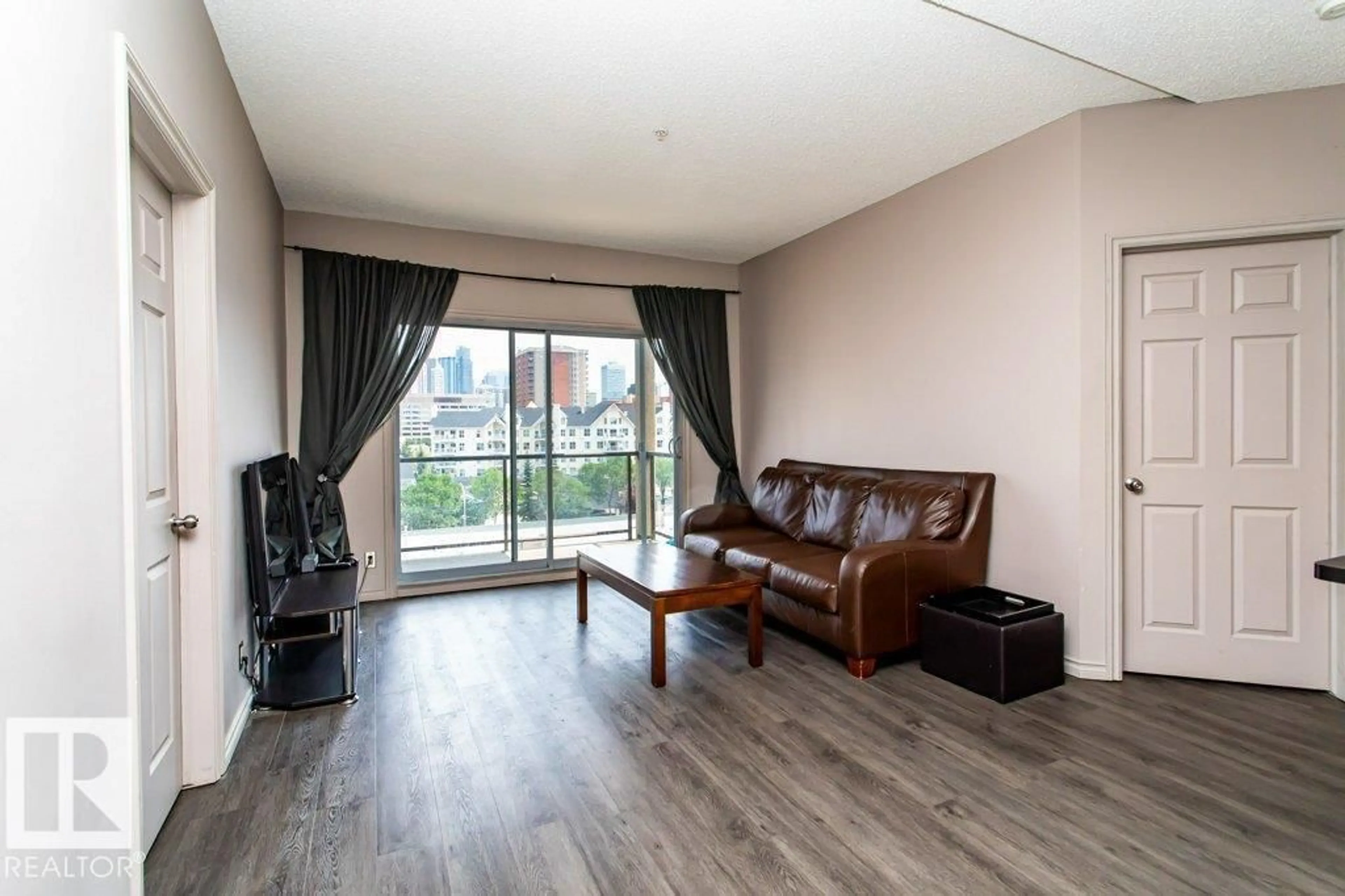 Living room with furniture, wood/laminate floor for 509 - 10235 112 ST, Edmonton Alberta T5K1M7