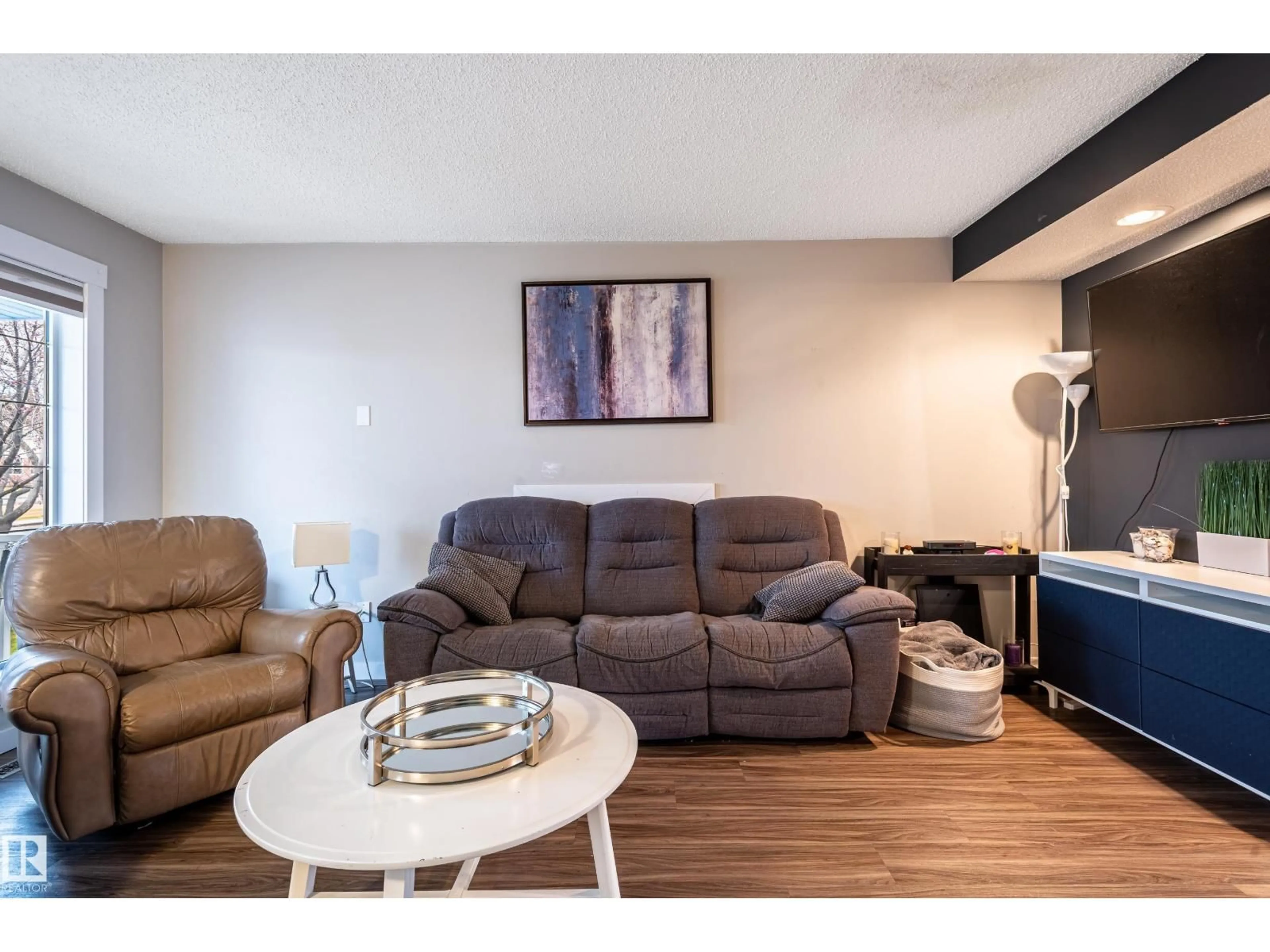 Living room with furniture, wood/laminate floor for 168 HEMINGWAY RD, Edmonton Alberta T6M2Y8
