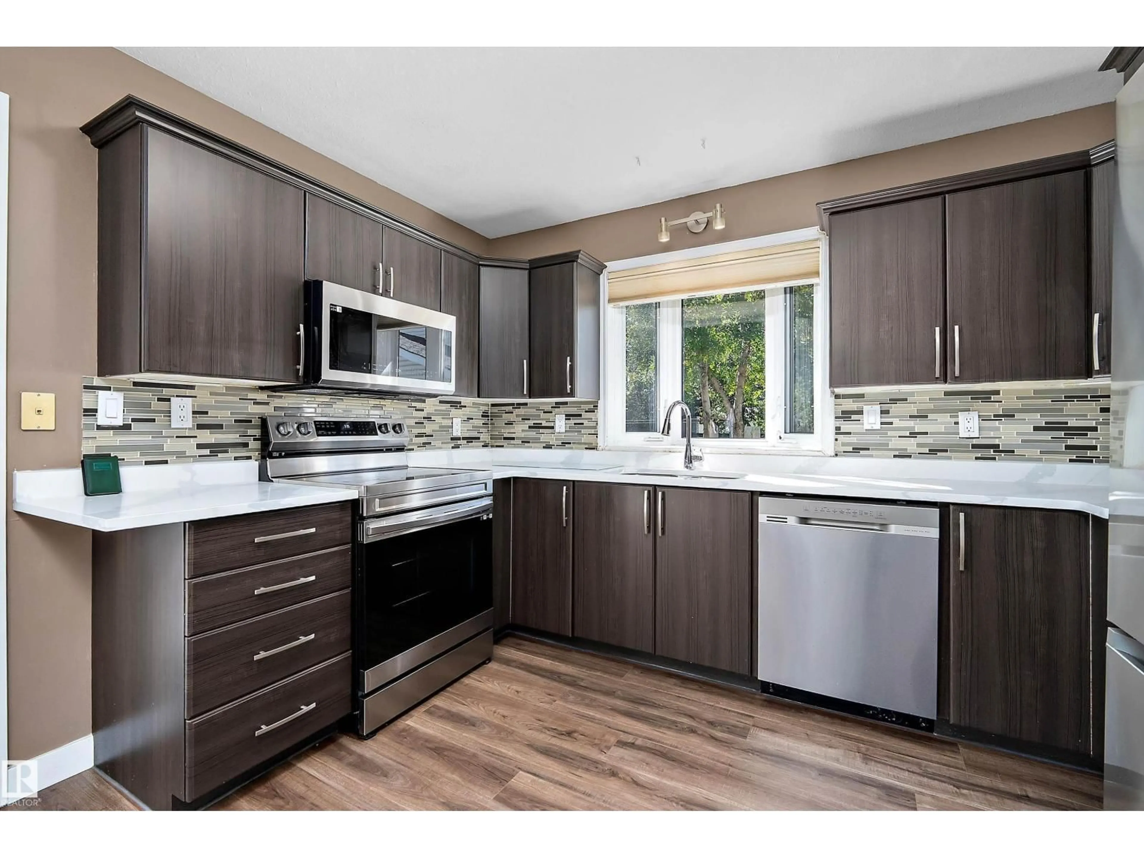 Open concept kitchen, wood/laminate floor for 18211 80 AV, Edmonton Alberta T5T0V3