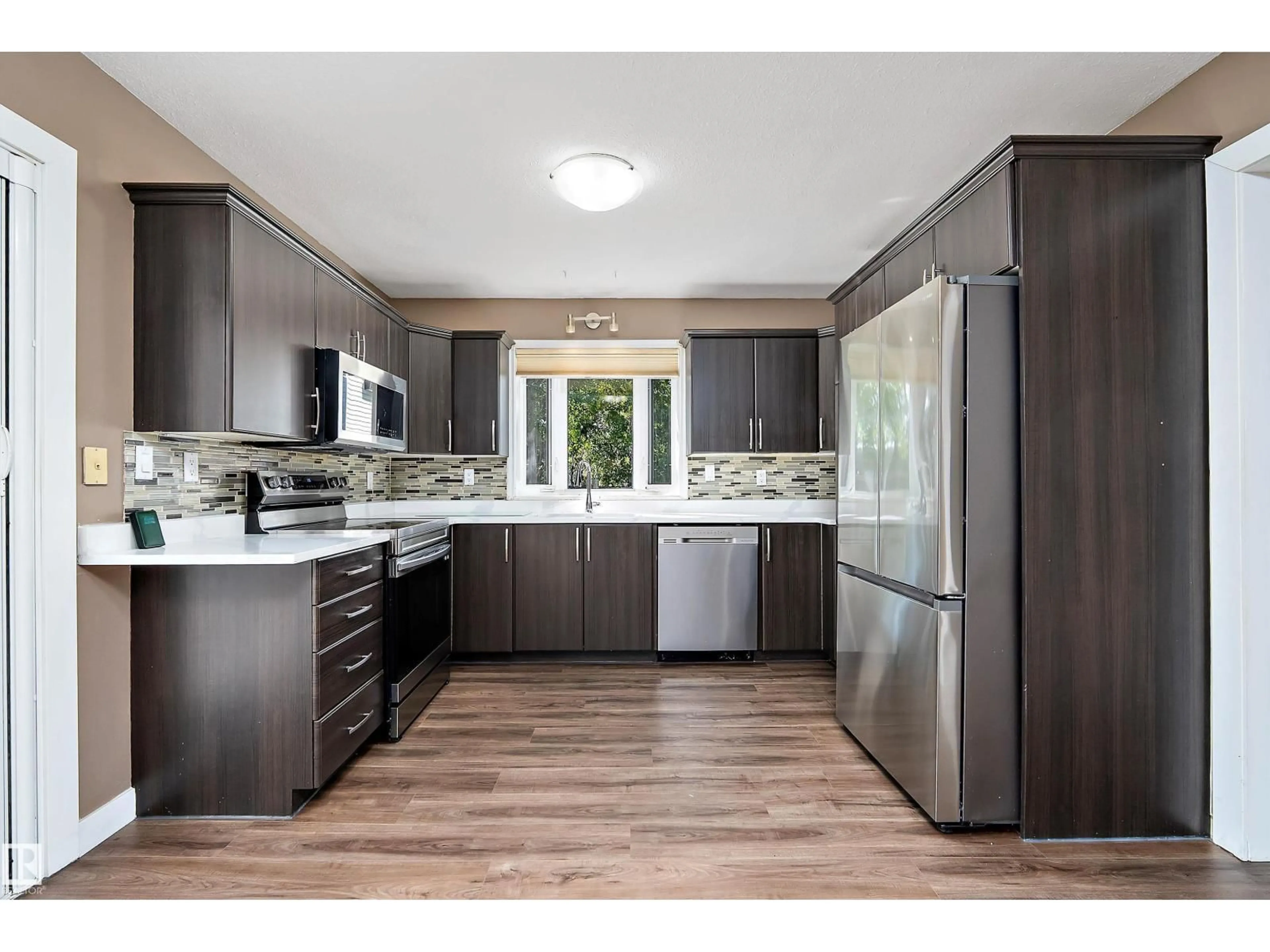 Open concept kitchen, wood/laminate floor for 18211 80 AV, Edmonton Alberta T5T0V3