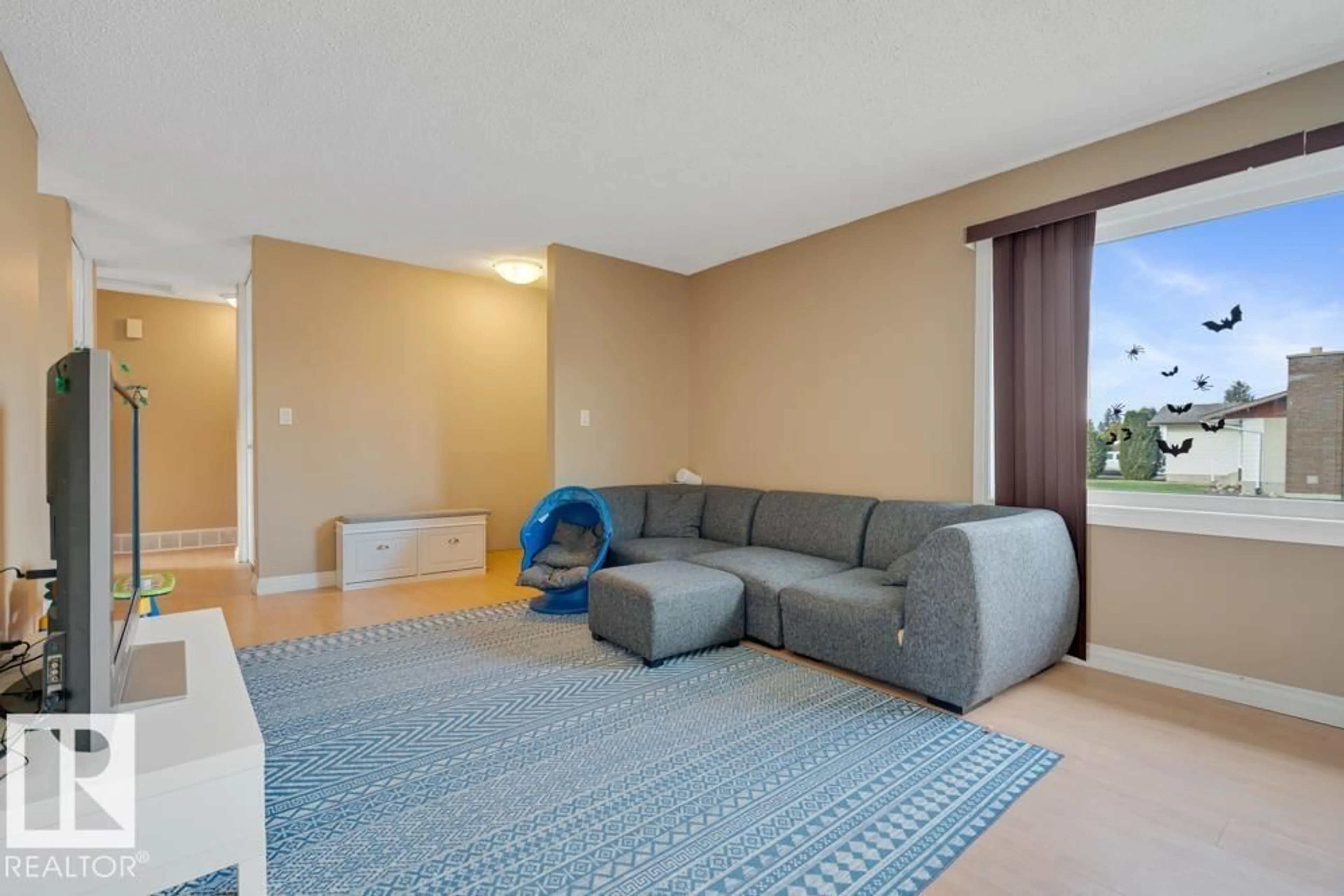 Living room with furniture, carpet floor for 10627 168 AV, Edmonton Alberta T5X2R7