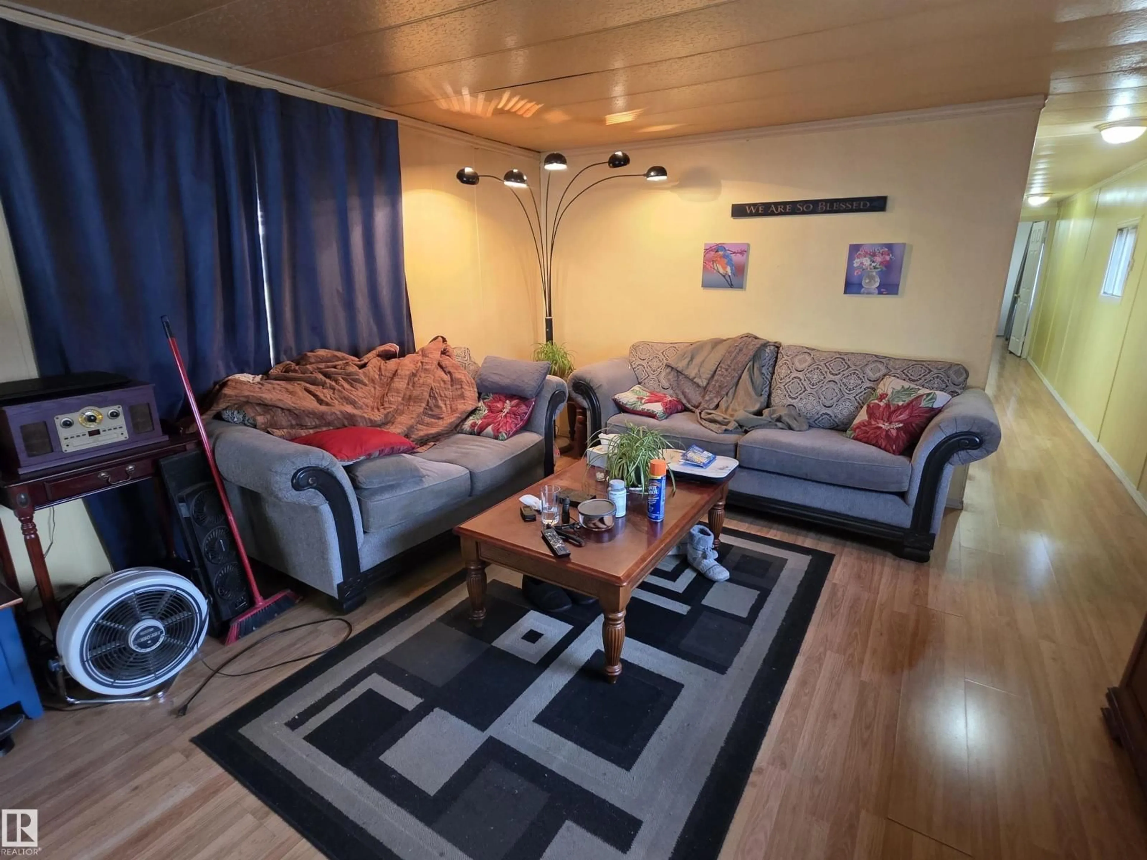 Living room with furniture, wood/laminate floor for 85 - 2251 50 ST, Drayton Valley Alberta T7A1M9