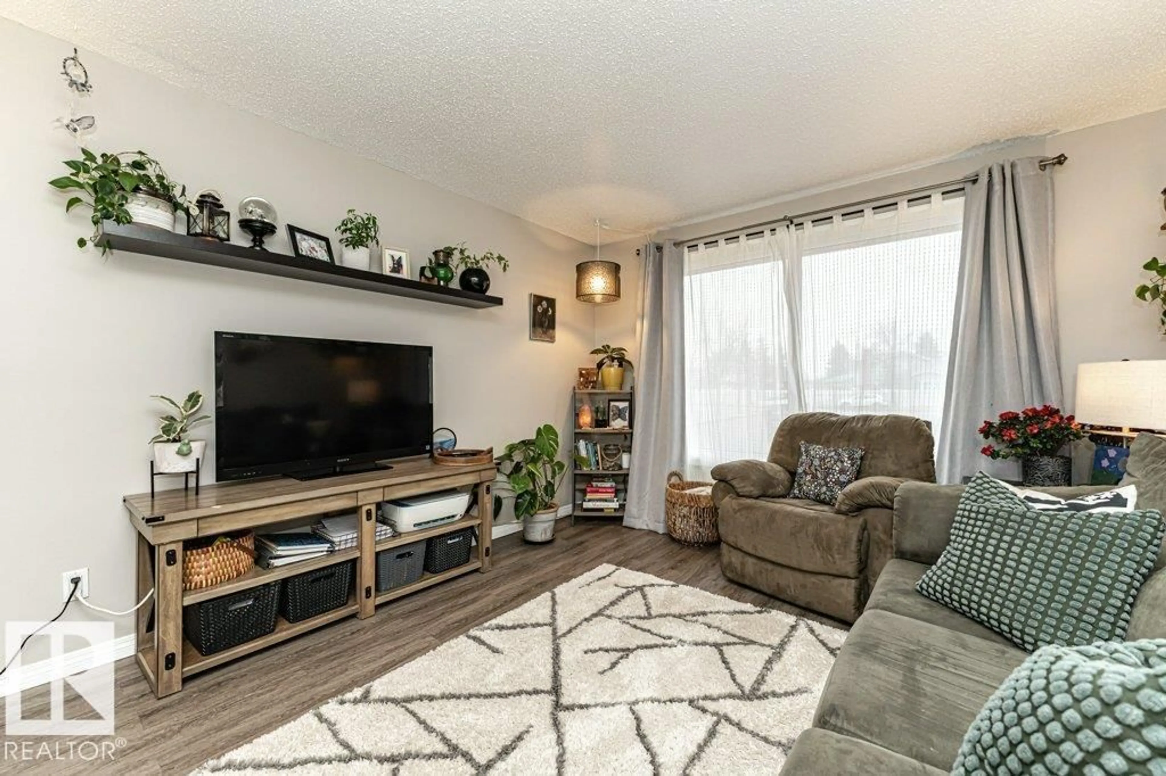 Living room with furniture, wood/laminate floor for 10944 BEAUMARIS RD NW, Edmonton Alberta T5X1Z6