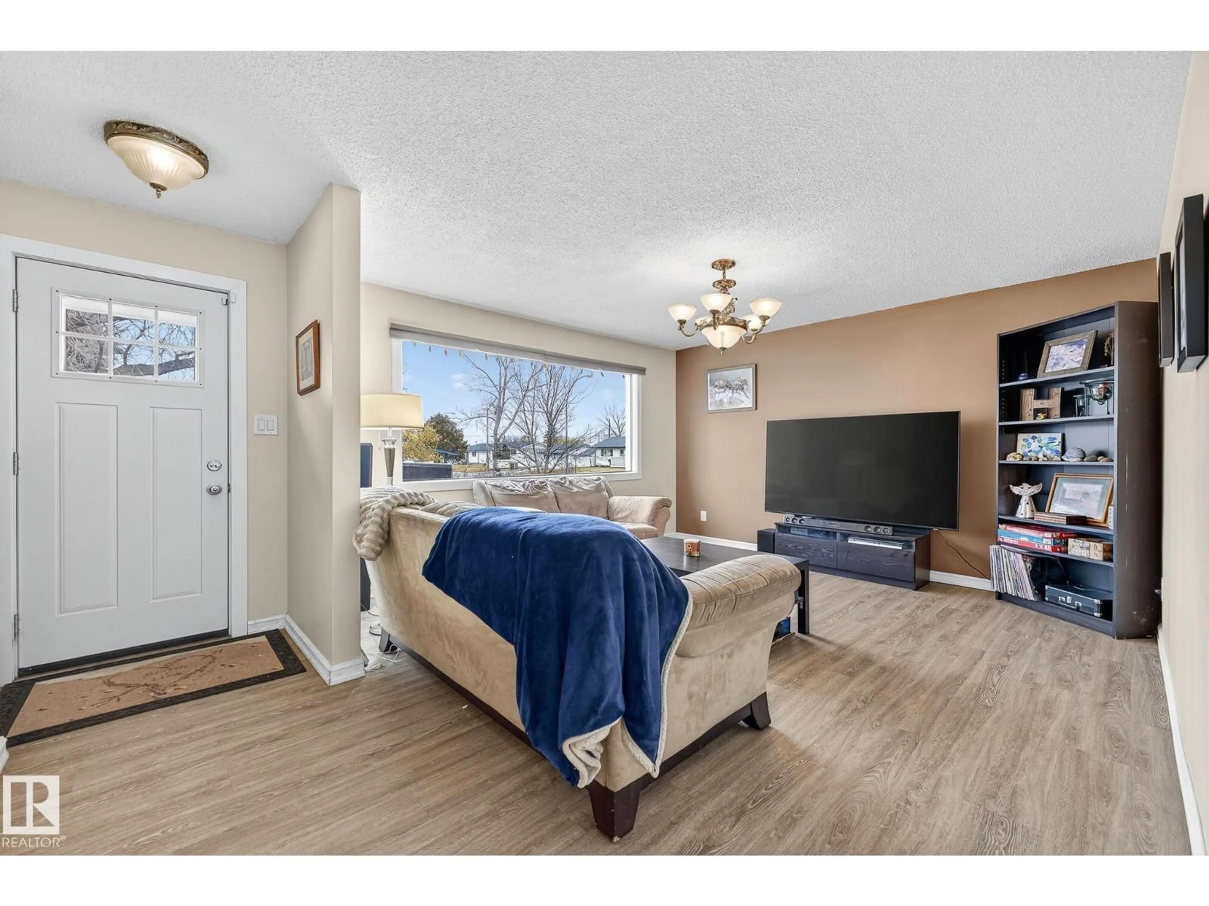 Living room with furniture, wood/laminate floor for 13108 62 ST, Edmonton Alberta T5A0V4
