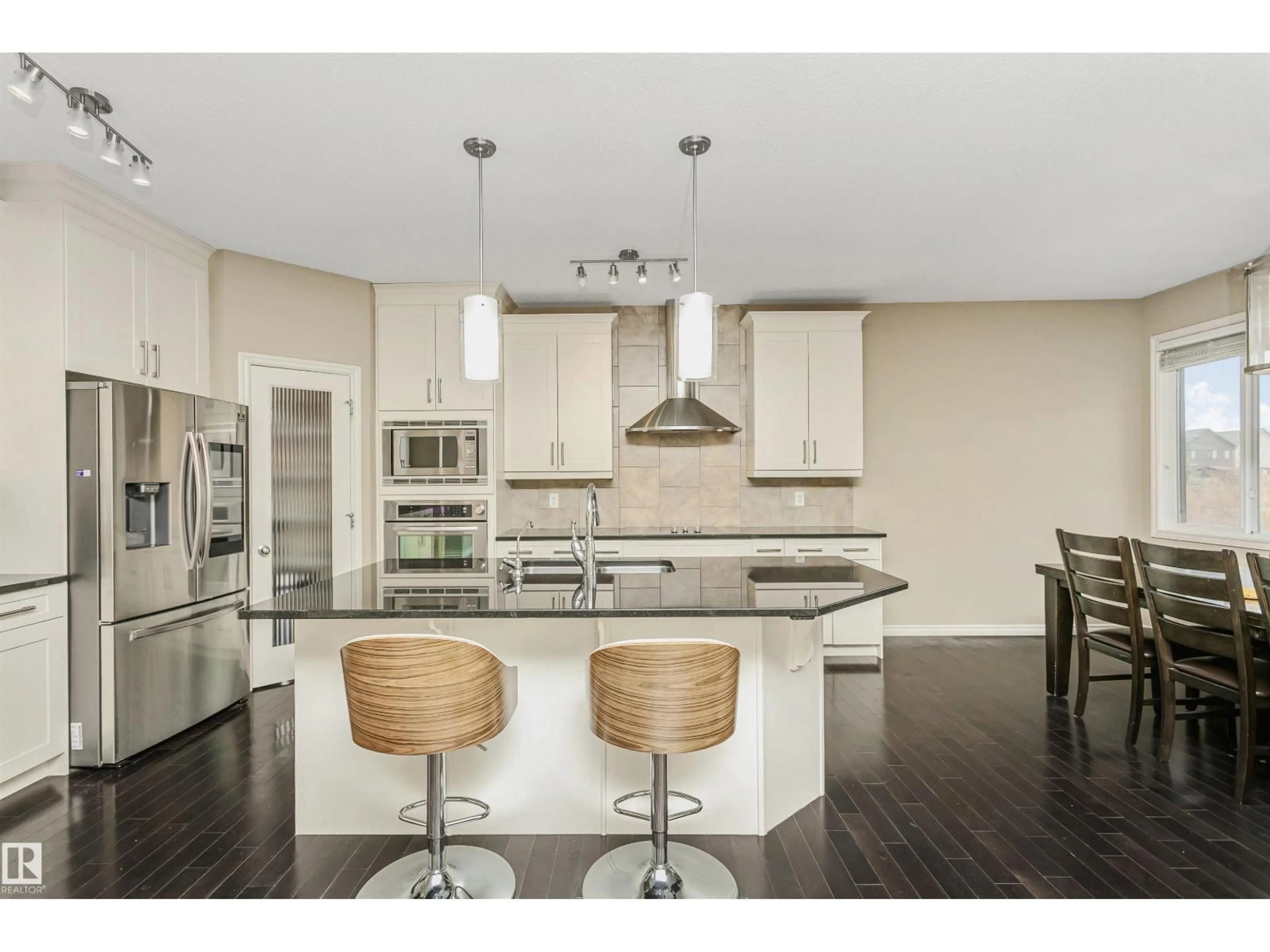 Open concept kitchen, wood/laminate floor for 1007 173 ST, Edmonton Alberta T6W1Z5