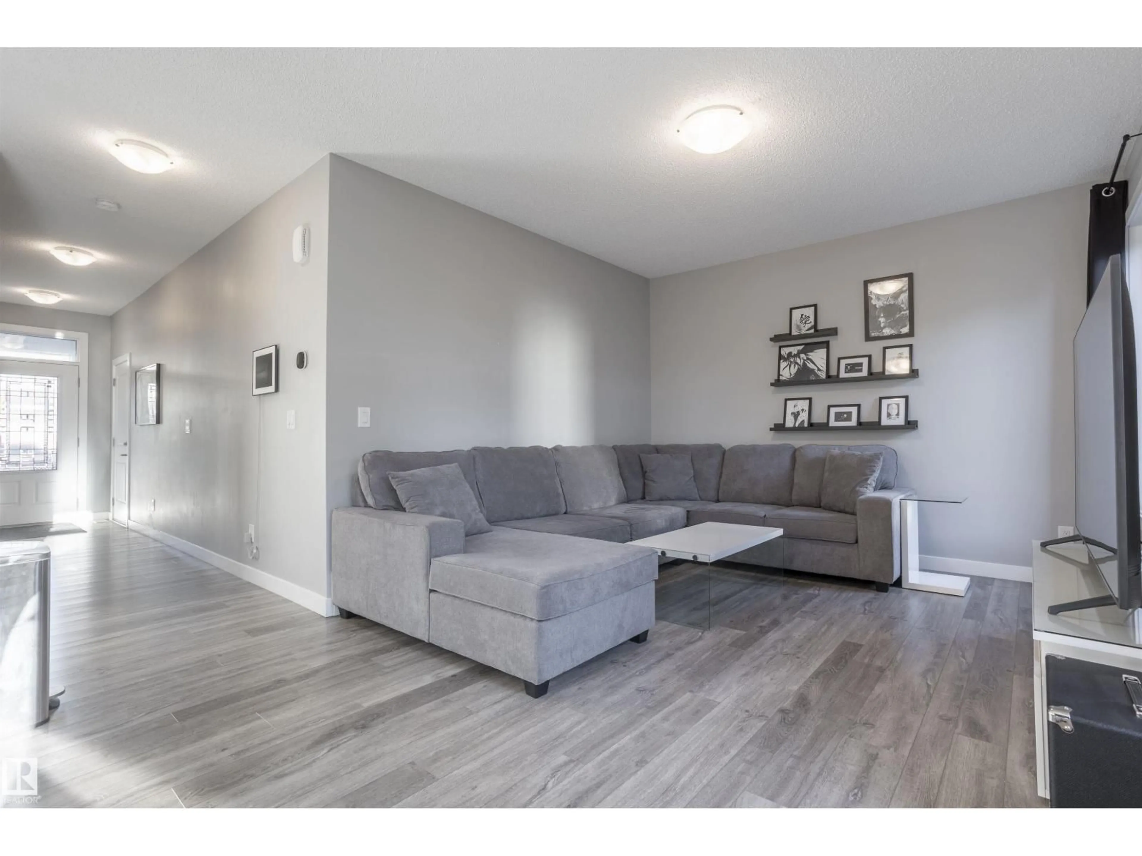 Living room with furniture, wood/laminate floor for NW - 20031 18 AV, Edmonton Alberta T6M0Y1