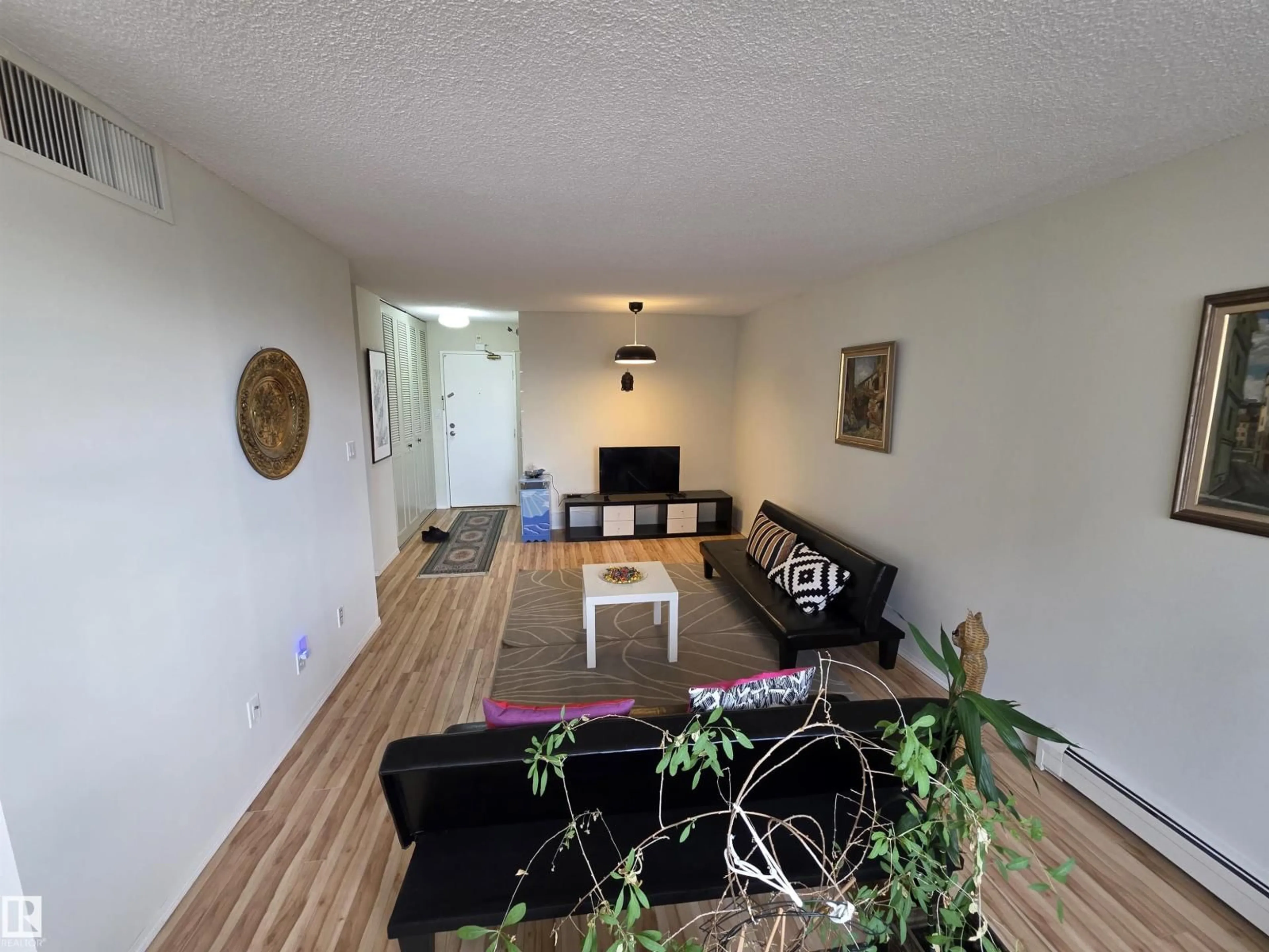 Living room with furniture, wood/laminate floor for 810 - 9909 104 ST NW, Edmonton Alberta T5K2G5