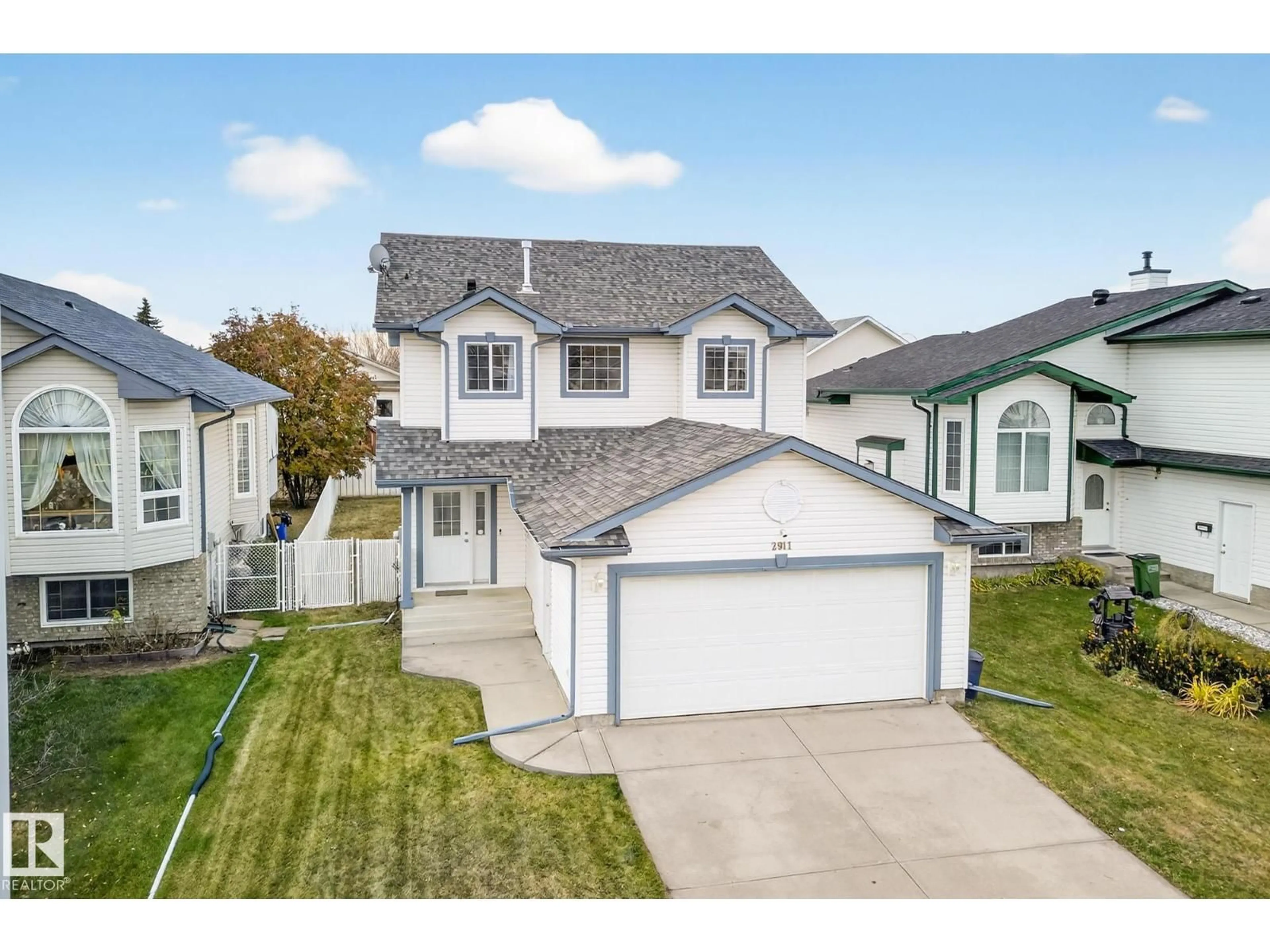 Home with vinyl exterior material, street for NW - 2911 151A AV, Edmonton Alberta T5Y2Y7