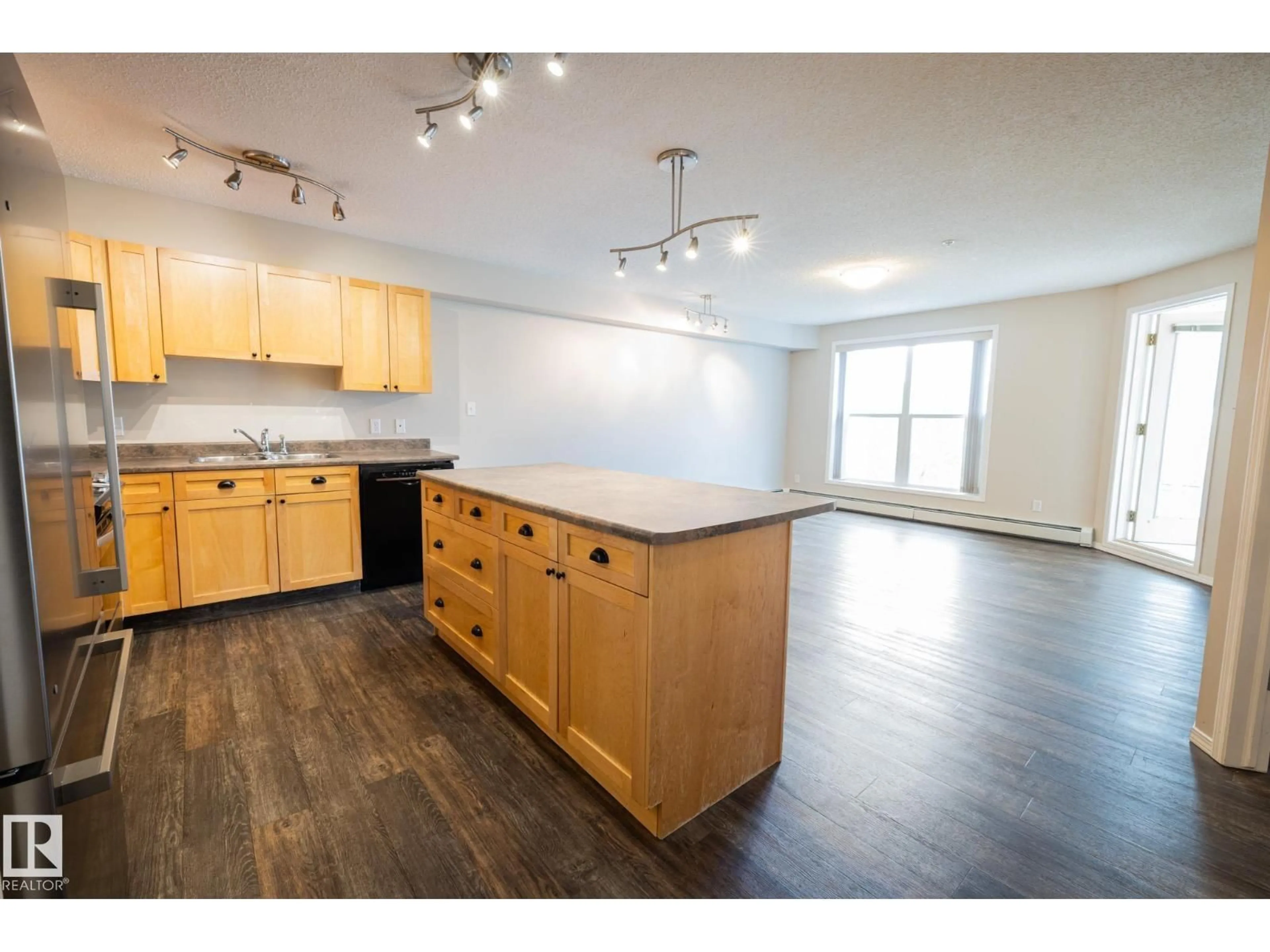 Open concept kitchen, wood/laminate floor for 406 - 10311 111 ST NW, Edmonton Alberta T5K2Y8