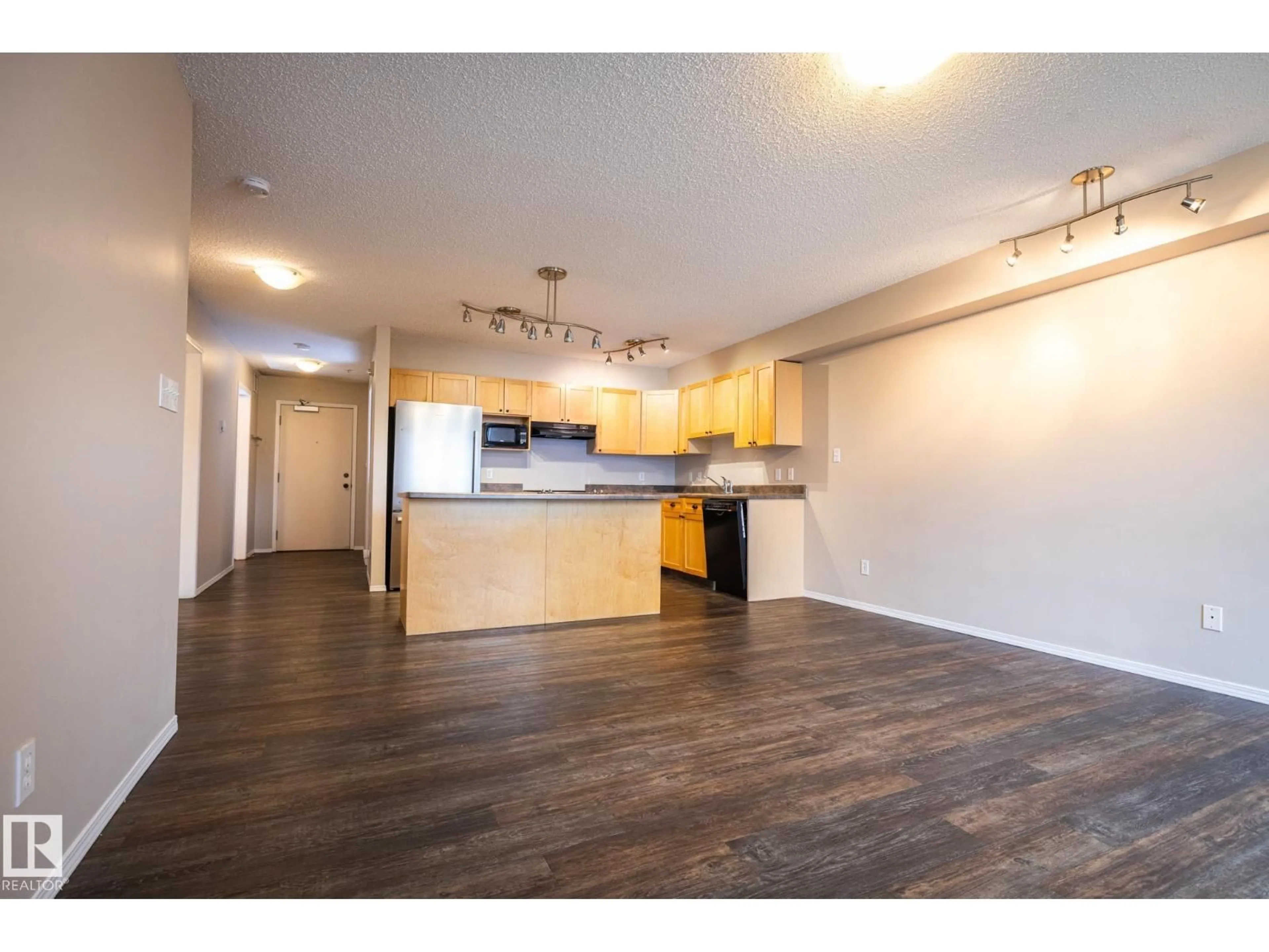 Open concept kitchen, wood/laminate floor for 406 - 10311 111 ST NW, Edmonton Alberta T5K2Y8