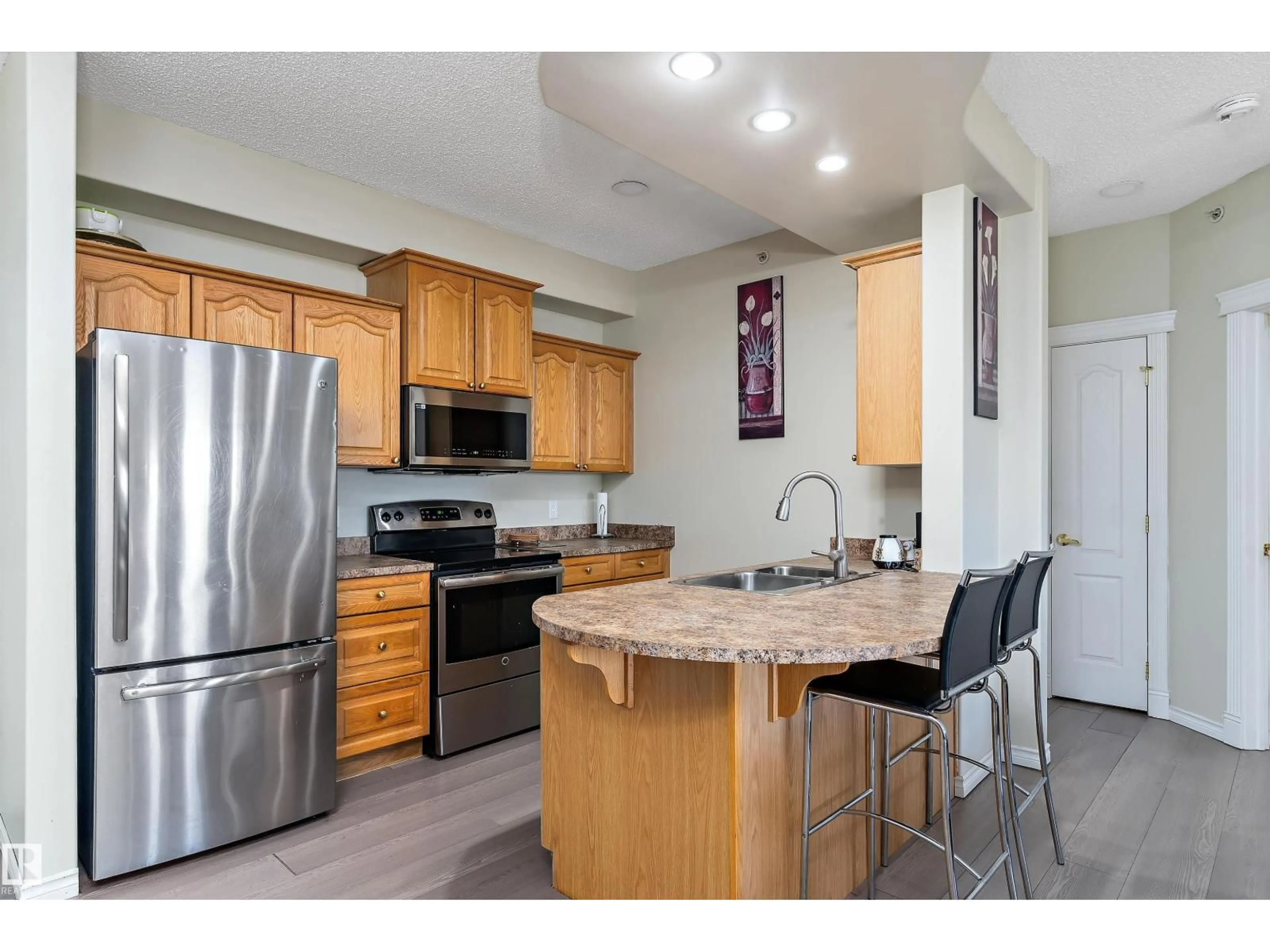Open concept kitchen, wood/laminate floor for #408 - 14259 50 ST, Edmonton Alberta T5A5J2