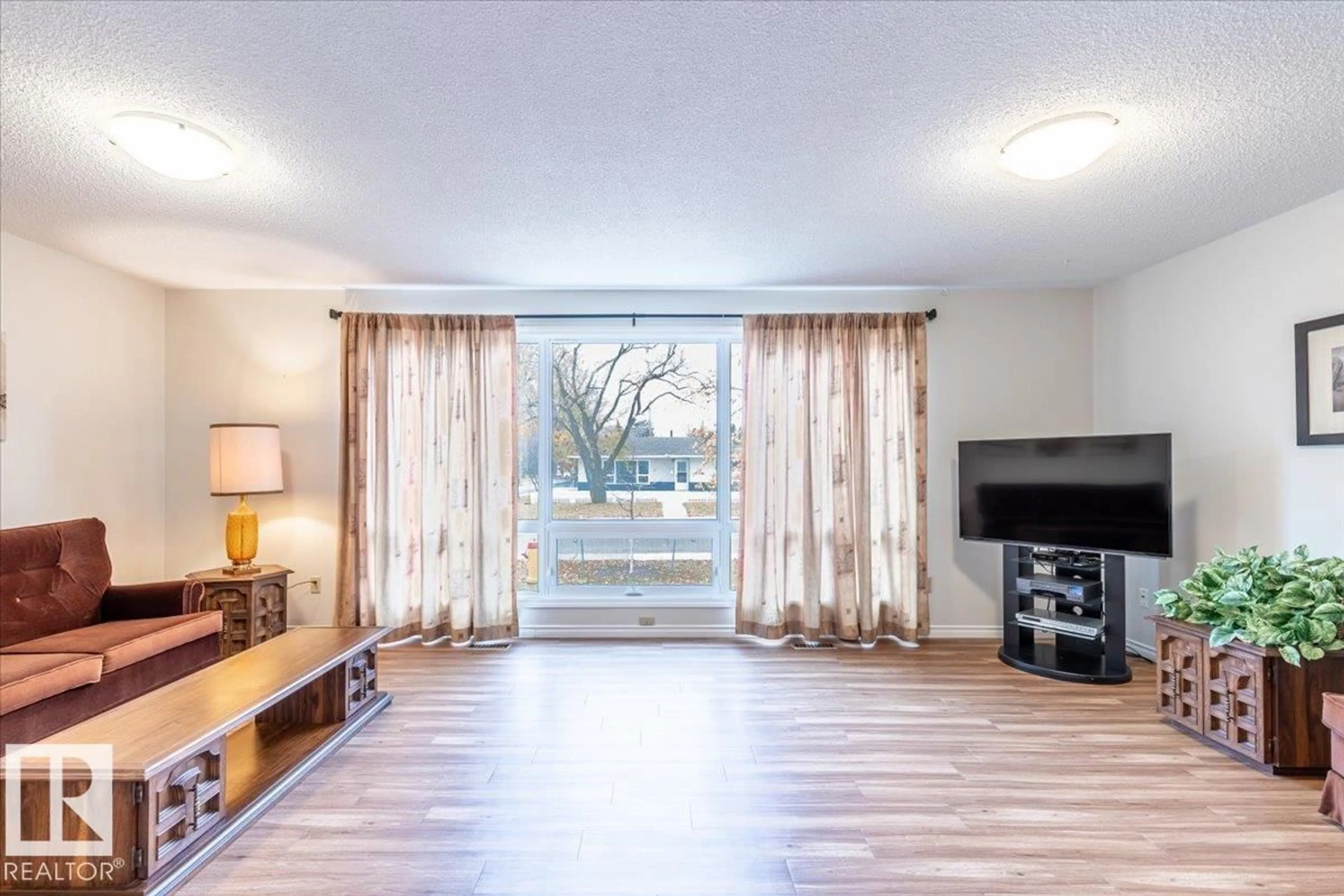 Living room with furniture, wood/laminate floor for 4702 52 ST, Leduc Alberta T9E5E7