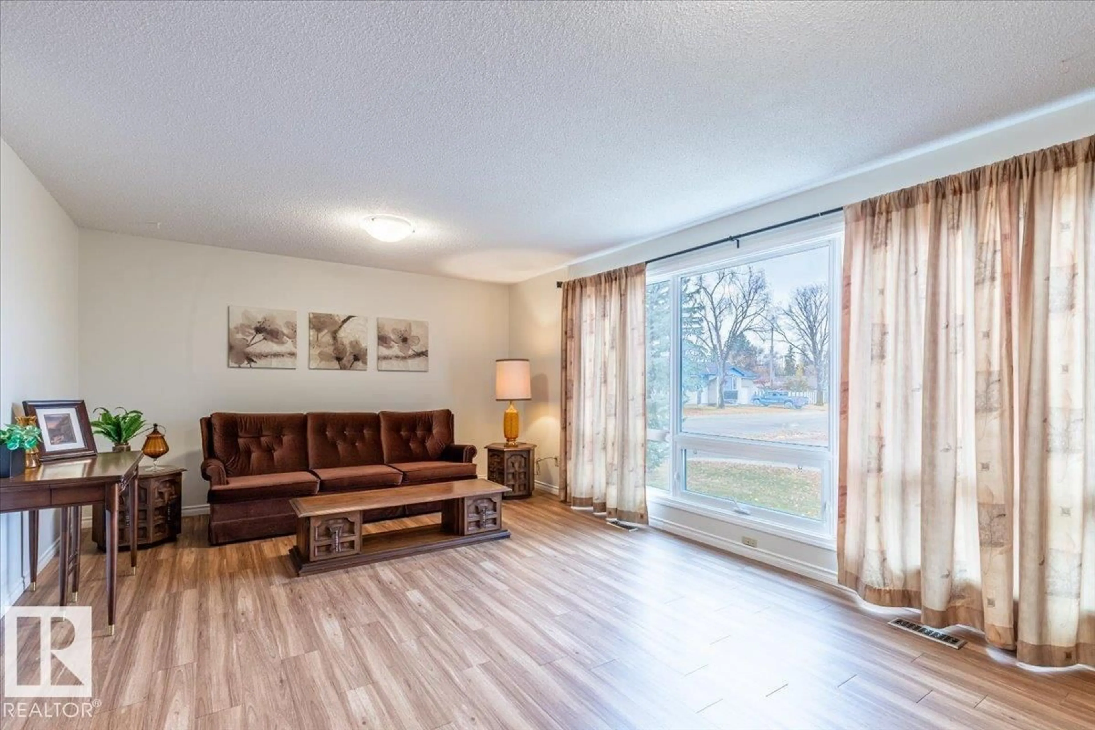 Living room with furniture, wood/laminate floor for 4702 52 ST, Leduc Alberta T9E5E7