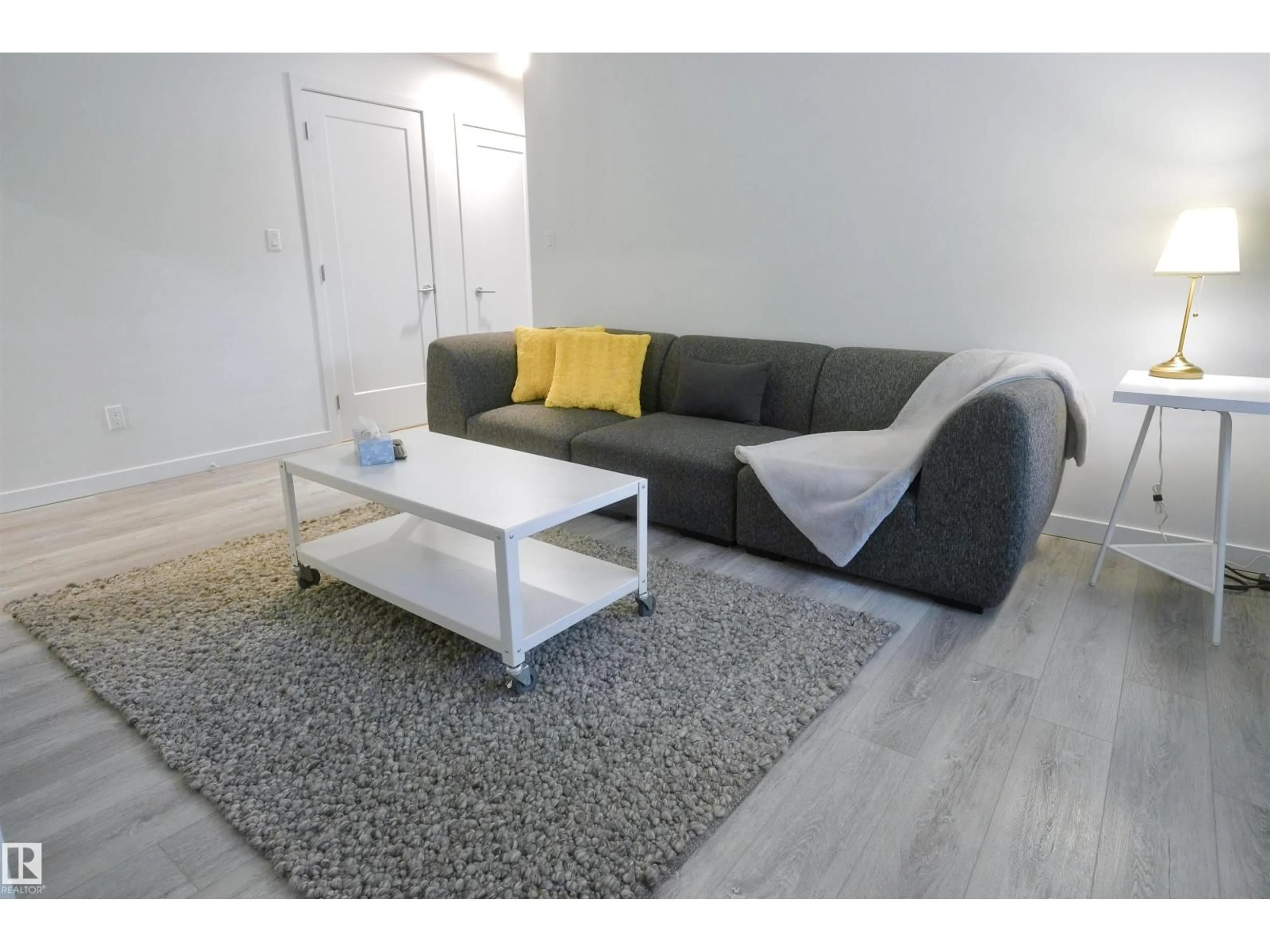 Living room with furniture, wood/laminate floor for #101 - 10625 83 AV, Edmonton Alberta T6E2E3