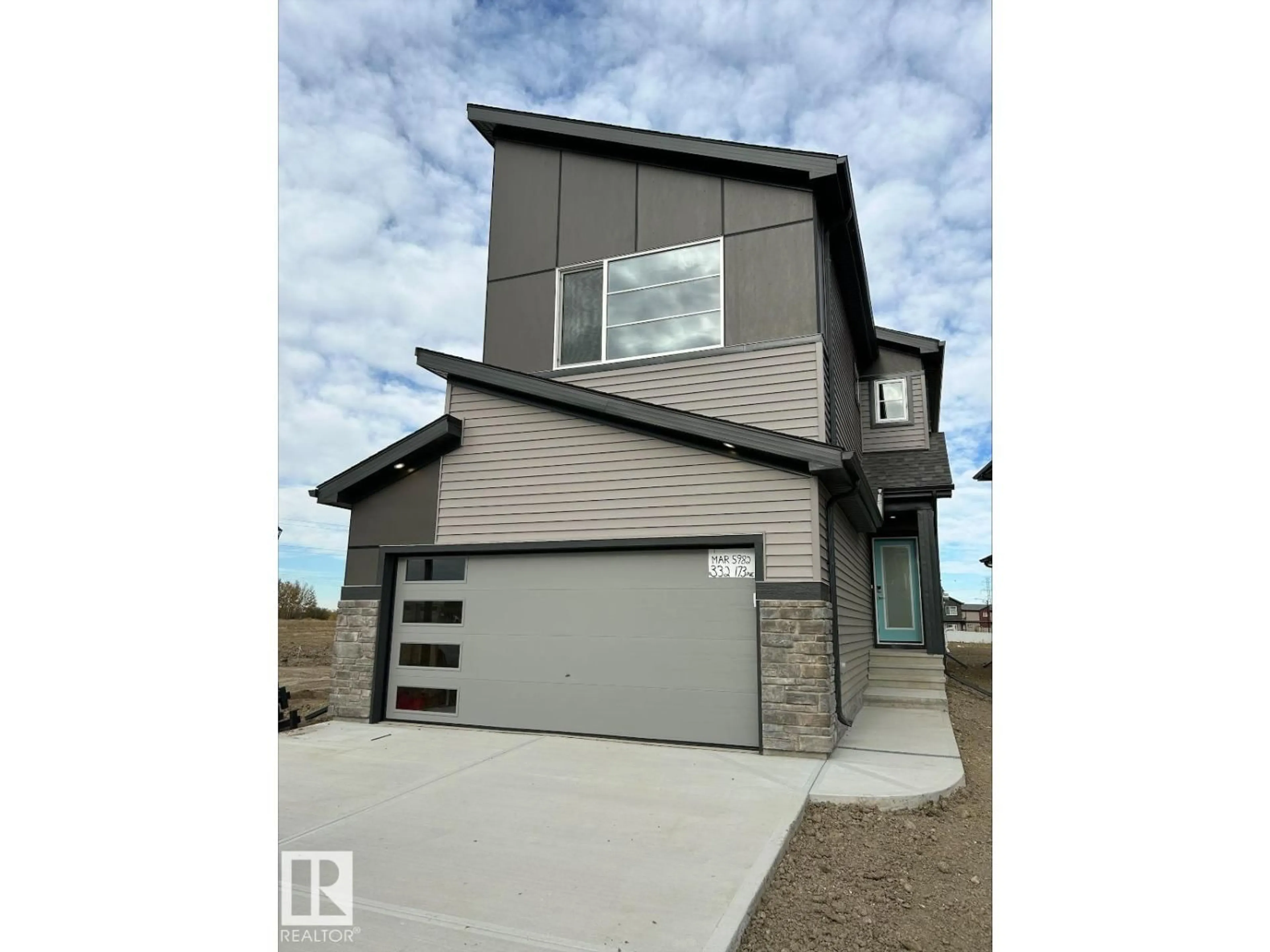 Home with vinyl exterior material, street for 332 173 AV, Edmonton Alberta T5Y4G6